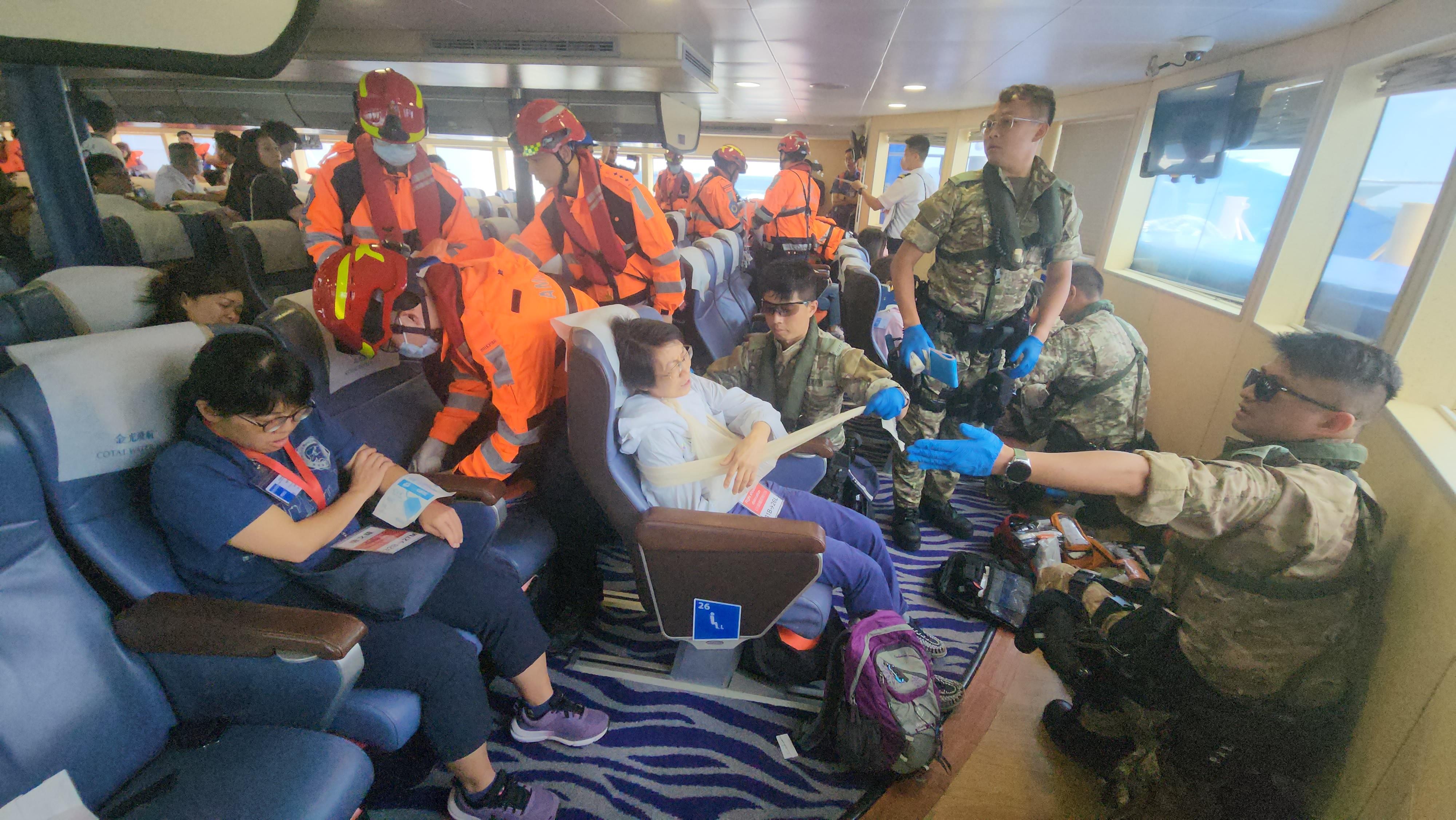 The Marine Department, in collaboration with the search and rescue (SAR) agencies in Guangdong and Macao as well as several Hong Kong government departments, smoothly conducted a joint maritime SAR exercise in the waters off Ha Mei Wan, Lamma Island, today (June 11). Photo shows ambulance crew providing first aid to the injured at the scene.