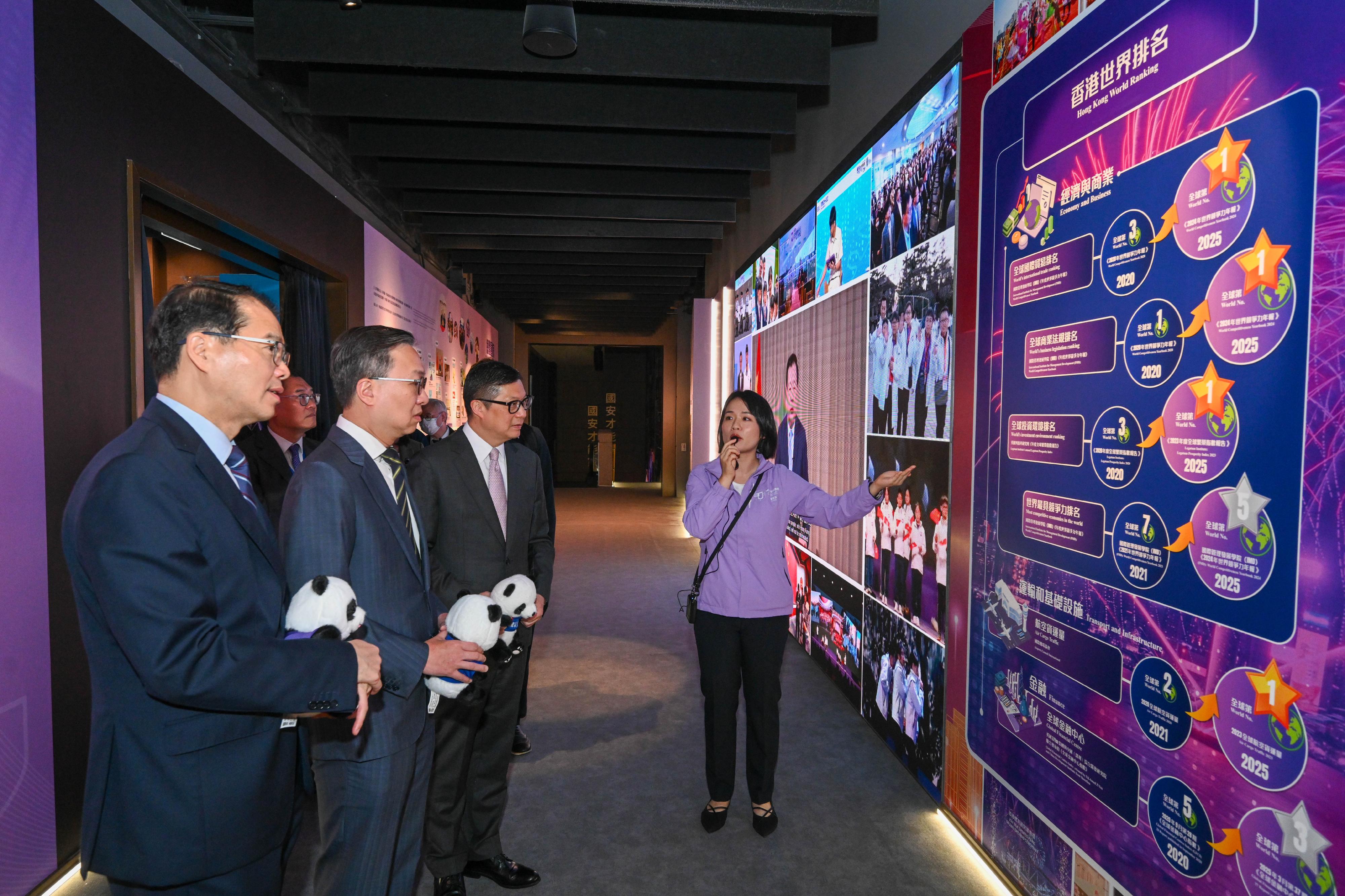 The Secretary for Justice, Mr Paul Lam, SC (second left), and the Secretary for Security, Mr Tang Ping-keung (third left), visit the 5th Anniversary of the Promulgation and Implementation of the Hong Kong National Security Law Thematic Exhibition.