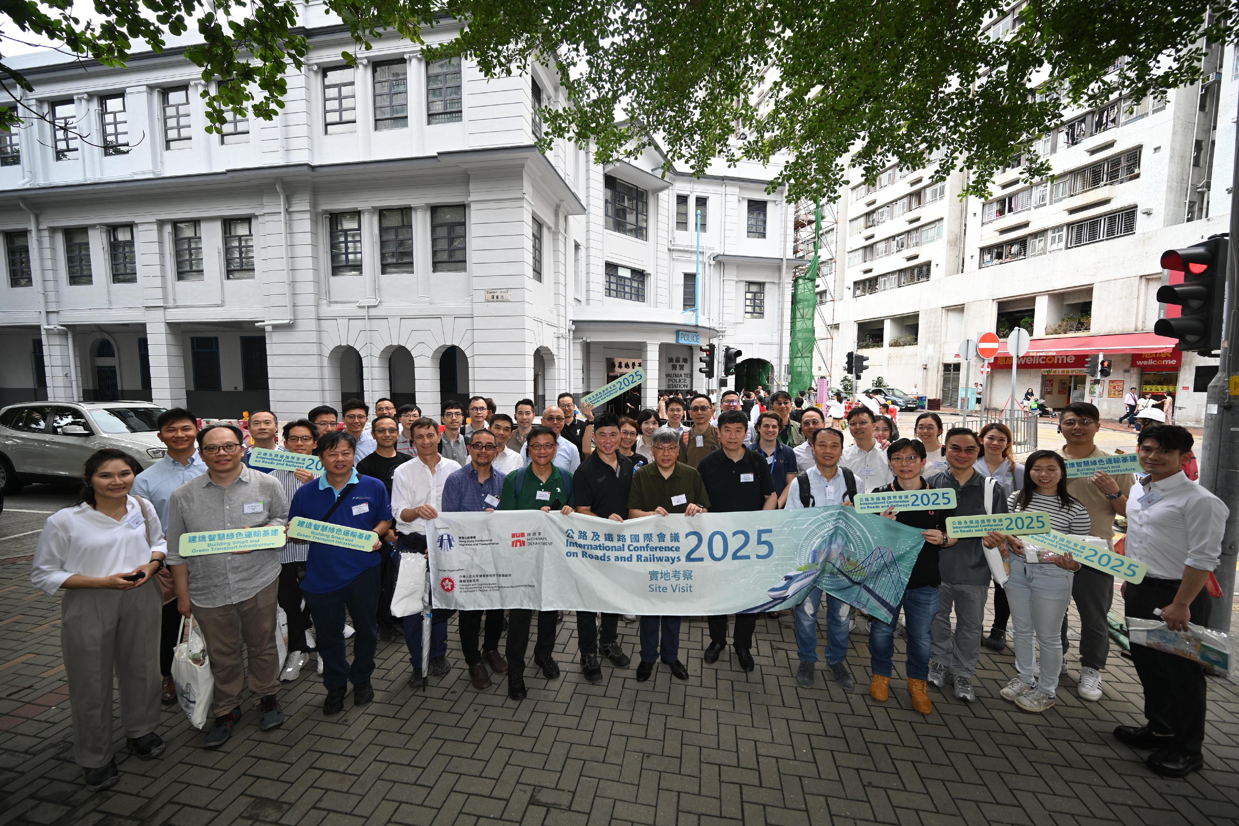 The two-day International Conference on Roads and Railways 2025 co-organised by the Highways Department and the Hong Kong Institution of Highways and Transportation successfully concluded yesterday (June 13). The participants were arranged to visit the works sites of the Central Kowloon Route (CKR) and the MTR Corporation Limited Tung Chung Line Extension projects respectively today (June 14). Photo shows the delegation visiting the Former Yau Ma Tei Police Station to understand the history of the building and the conservation engineering technology related to the CKR project. 