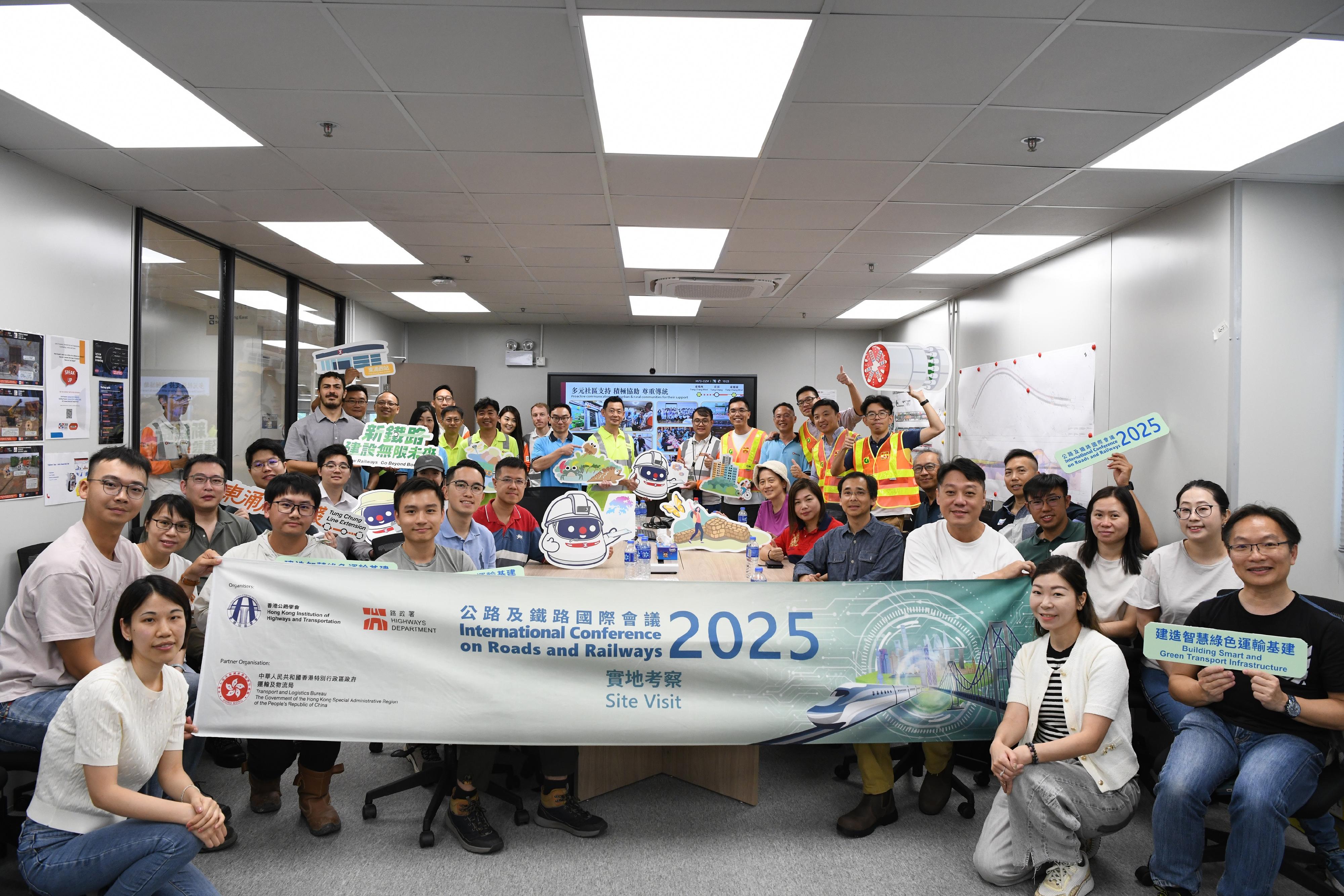 The two-day International Conference on Roads and Railways 2025 co-organised by the Highways Department (HyD) and the Hong Kong Institution of Highways and Transportation successfully concluded yesterday (June 13). The participants were arranged to visit the works sites of the Central Kowloon Route and the MTR Corporation Limited (MTRCL) Tung Chung Line Extension (TUE) projects respectively today (June 14). The delegation is pictured with the representatives of the HyD and the MTRCL TUE project team after being briefed on the project.
