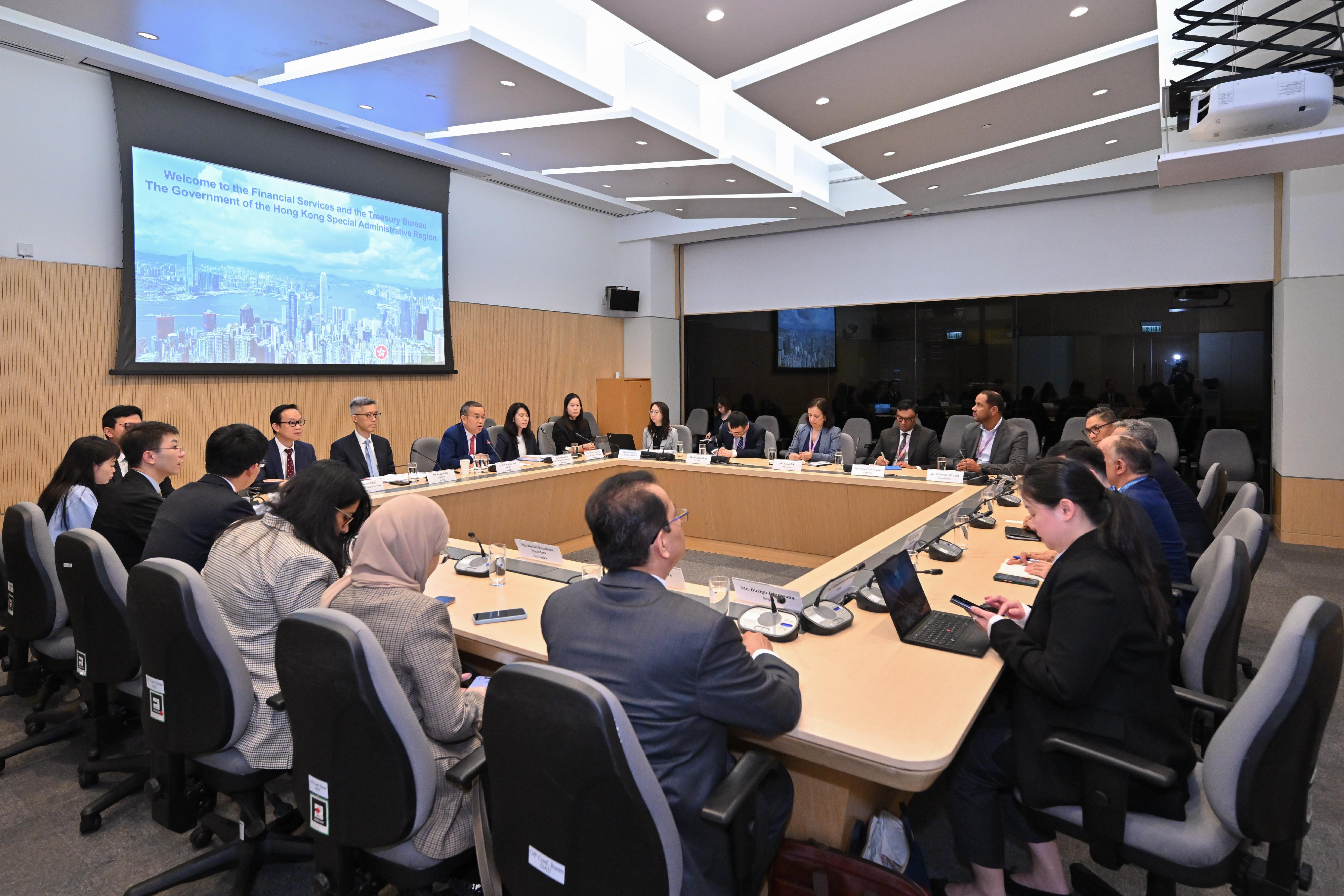 A delegation of 10 overseas government officials completed their three-day visit in Hong Kong today (June 18). Photo shows the delegation meeting with the Secretary for Financial Services and the Treasury, Mr Christopher Hui (fourth left), to explore financial co-operation opportunities. 