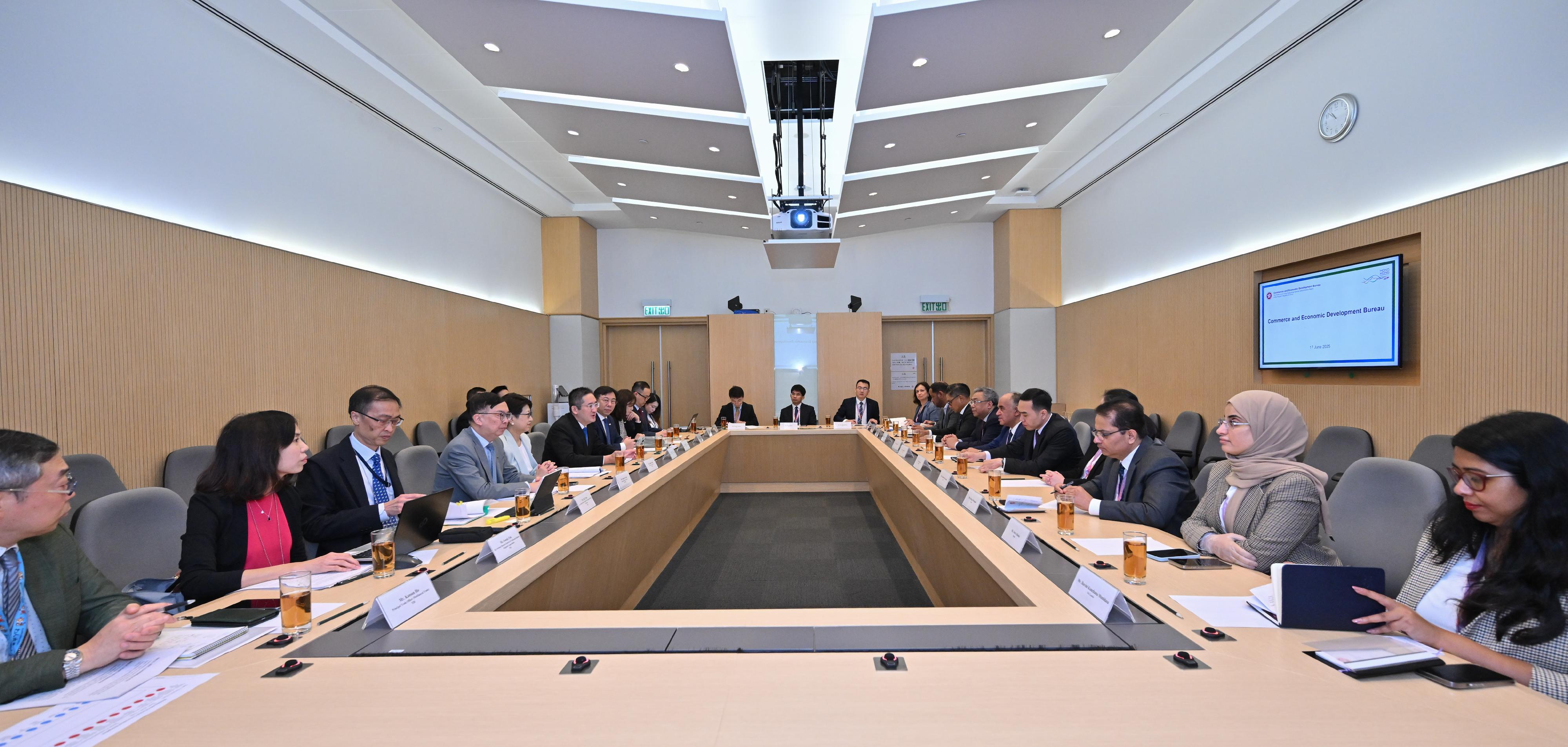 A delegation of 10 overseas government officials completed their three-day visit in Hong Kong today (June 18). Photo shows the delegation meeting with the Under Secretary for Commerce and Economic Development, Dr Bernard Chan (sixth left), on Hong Kong's major initiatives for promoting economic development. 