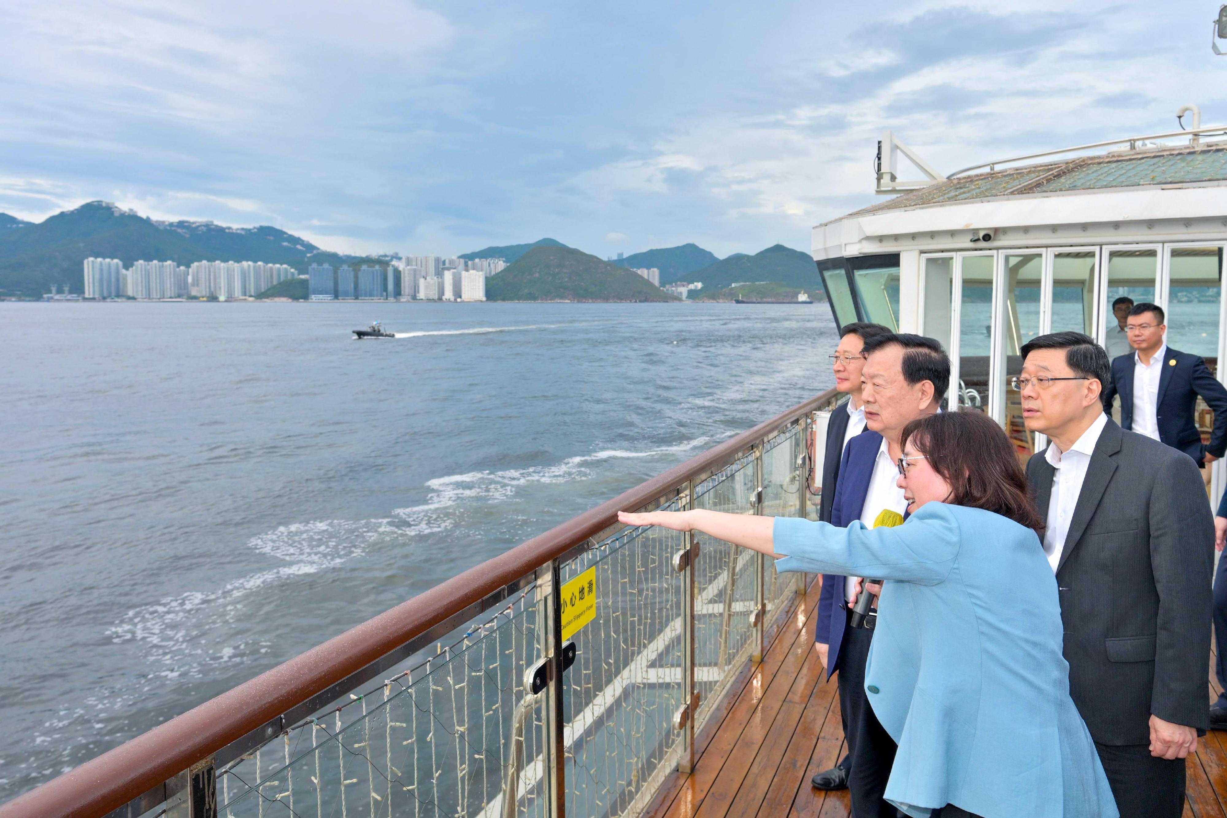 The Director of the Hong Kong and Macao Work Office of the Communist Party of China Central Committee and the Hong Kong and Macao Affairs Office of the State Council, Mr Xia Baolong (second left), today (June 20), took a boat trip to Lamma Island with the Chief Executive, Mr John Lee (first right) and the Secretary for Development, Ms Bernadette Linn (second right), to gain an understanding of the ex-Lamma quarry site's development plan.