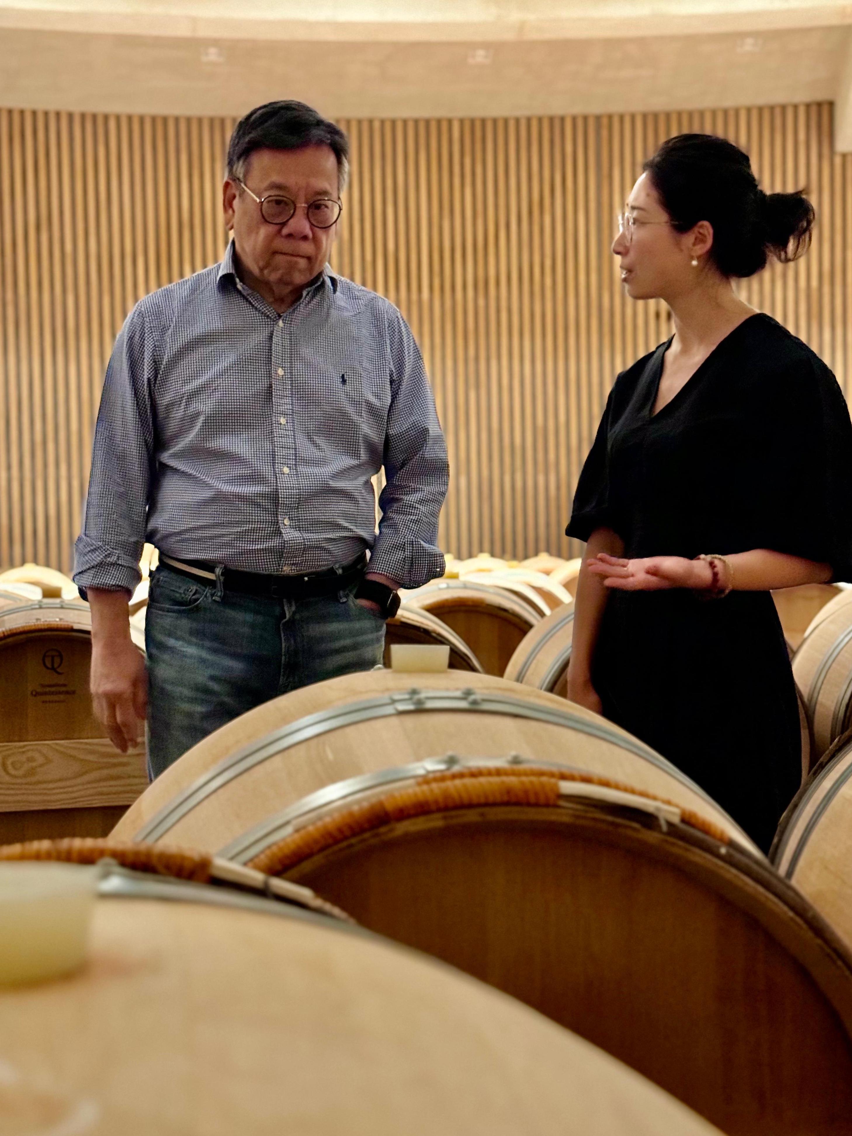 The Secretary for Commerce and Economic Development, Mr Algernon Yau, continued his visit to Bordeaux, France, to promote the advantages of Hong Kong as a wine and liquor trading hub to the local trade. Photo shows Mr Yau (left) visiting a vineyard in Bordeaux on June 21 (France time) to learn about its operations.