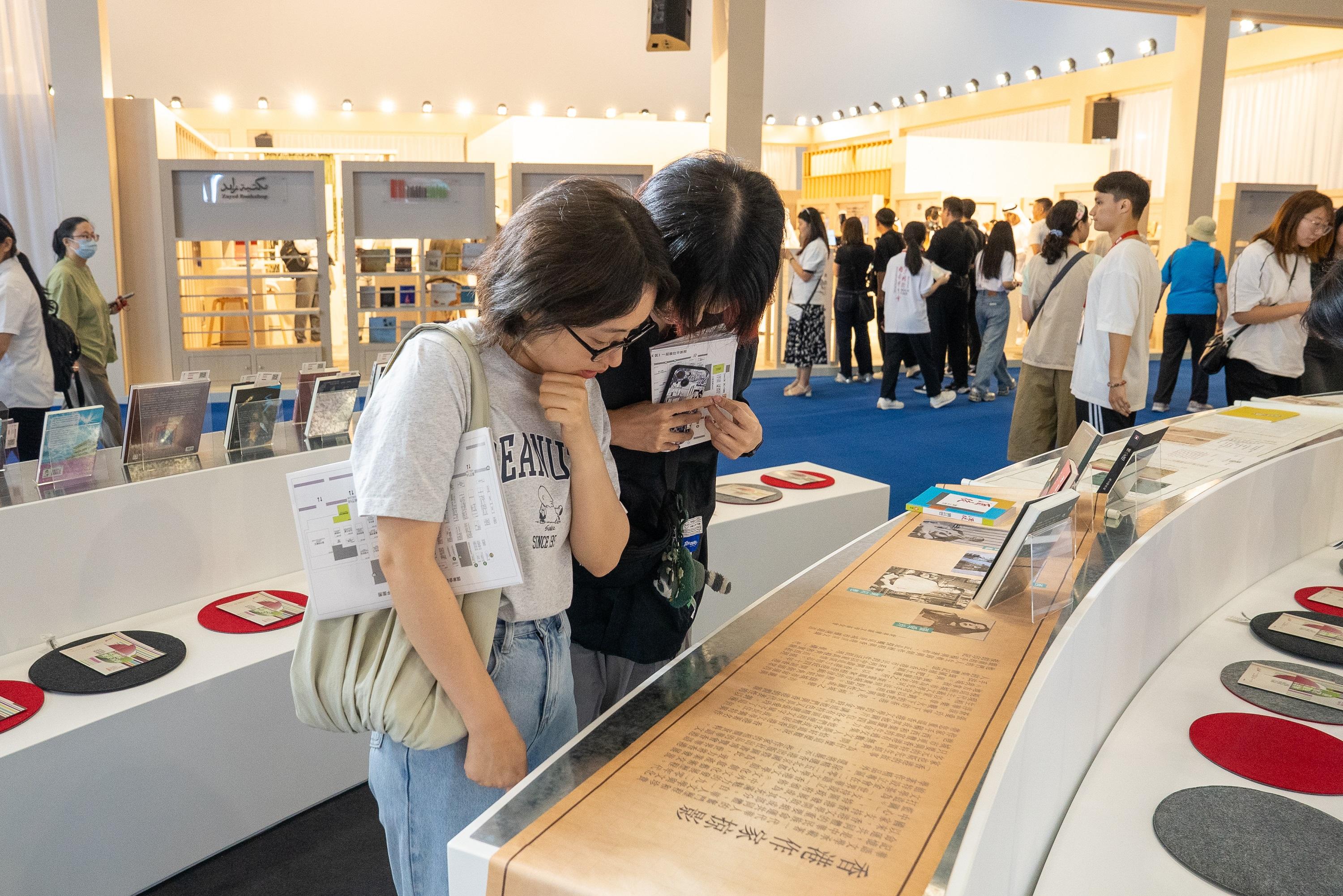 The Cultural and Creative Industries Development Agency (CCIDA) of the Culture, Sports and Tourism Bureau led an industry delegation to participate in the 31st edition of the Beijing International Book Fair and organised the Hong Kong Pavilion on June 18 to 22. Photo shows visitors viewing exhibits of Chinese writers in the zone "A Glimpse of Hong Kong Writers" in the Hong Kong Pavilion.
