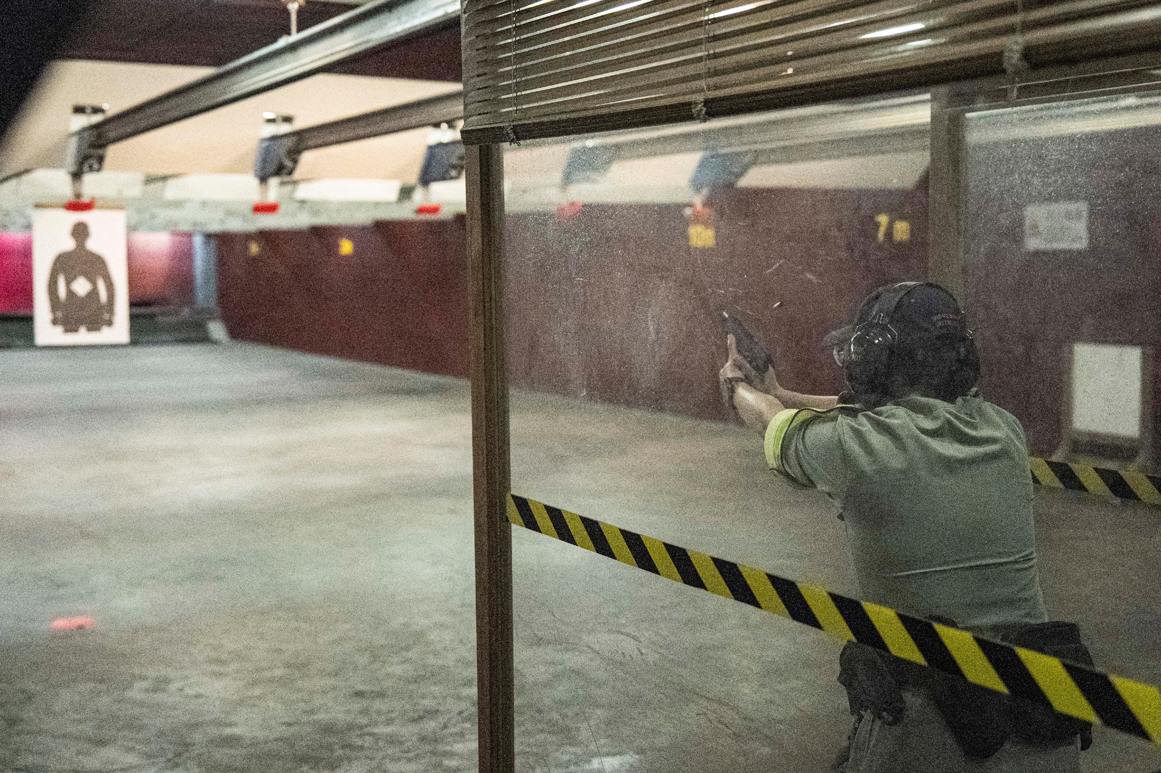 The Hong Kong Police Force today (June 22) held the Police Recruitment Experience and Assessment Day at the Hong Kong Police College. A Police officer demonstrates the pistol firing training to participants at the indoor shooting range.
