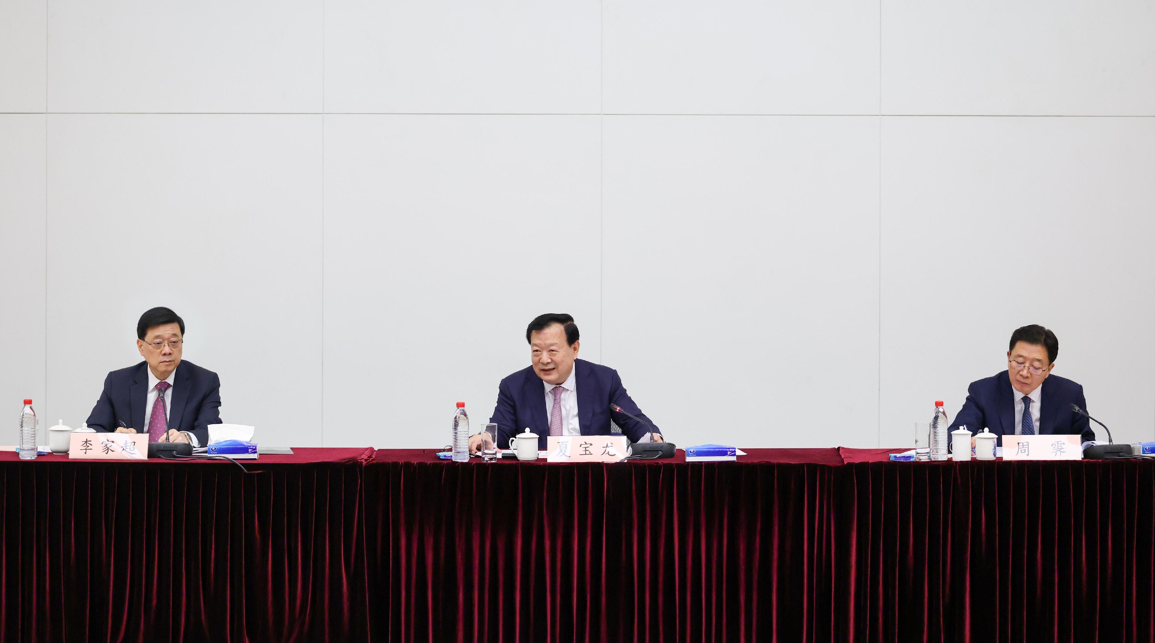 The Director of the Hong Kong and Macao Work Office of the Communist Party of China Central Committee and the Hong Kong and Macao Affairs Office of the State Council, Mr Xia Baolong (centre), today (June 22) met with the chairmen and representatives of the 18 District Councils at the engagement session and received briefings on their district work. The Chief Executive, Mr John Lee (left), and the Director of the Liaison Office of the Central People's Government in the Hong Kong Special Administrative Region, Mr Zhou Ji (right), also attended.