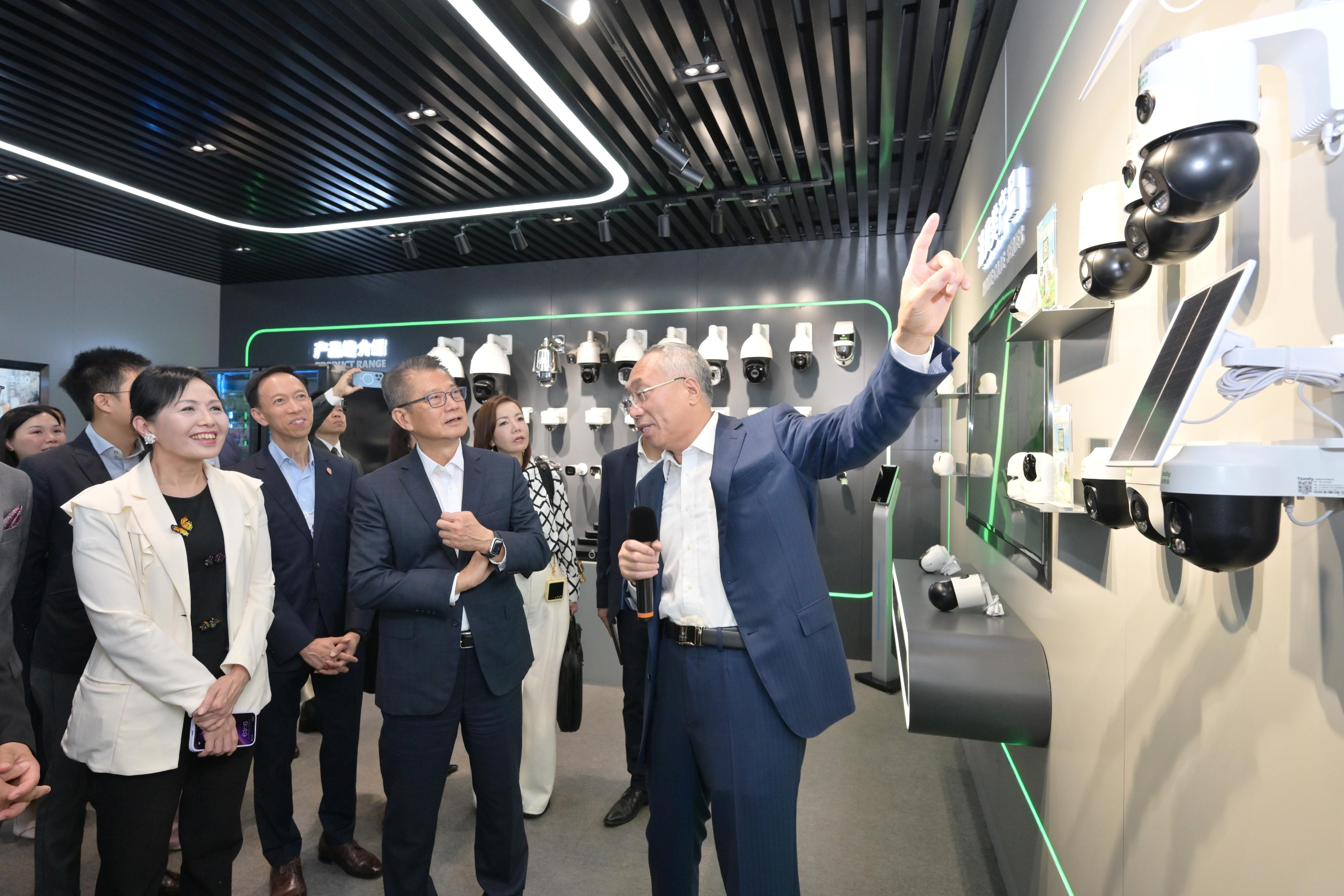 The Financial Secretary, Mr Paul Chan (second right), visited Tianjin today (June 24) and attended the World Economic Forum Annual Meeting of the New Champions 2025 (also known as Summer Davos). Photo shows Mr Chan visiting the Tianjin Binhai High-tech Industrial Development Area and touring an innovative enterprise engaged in the smart city business in the Area. 
