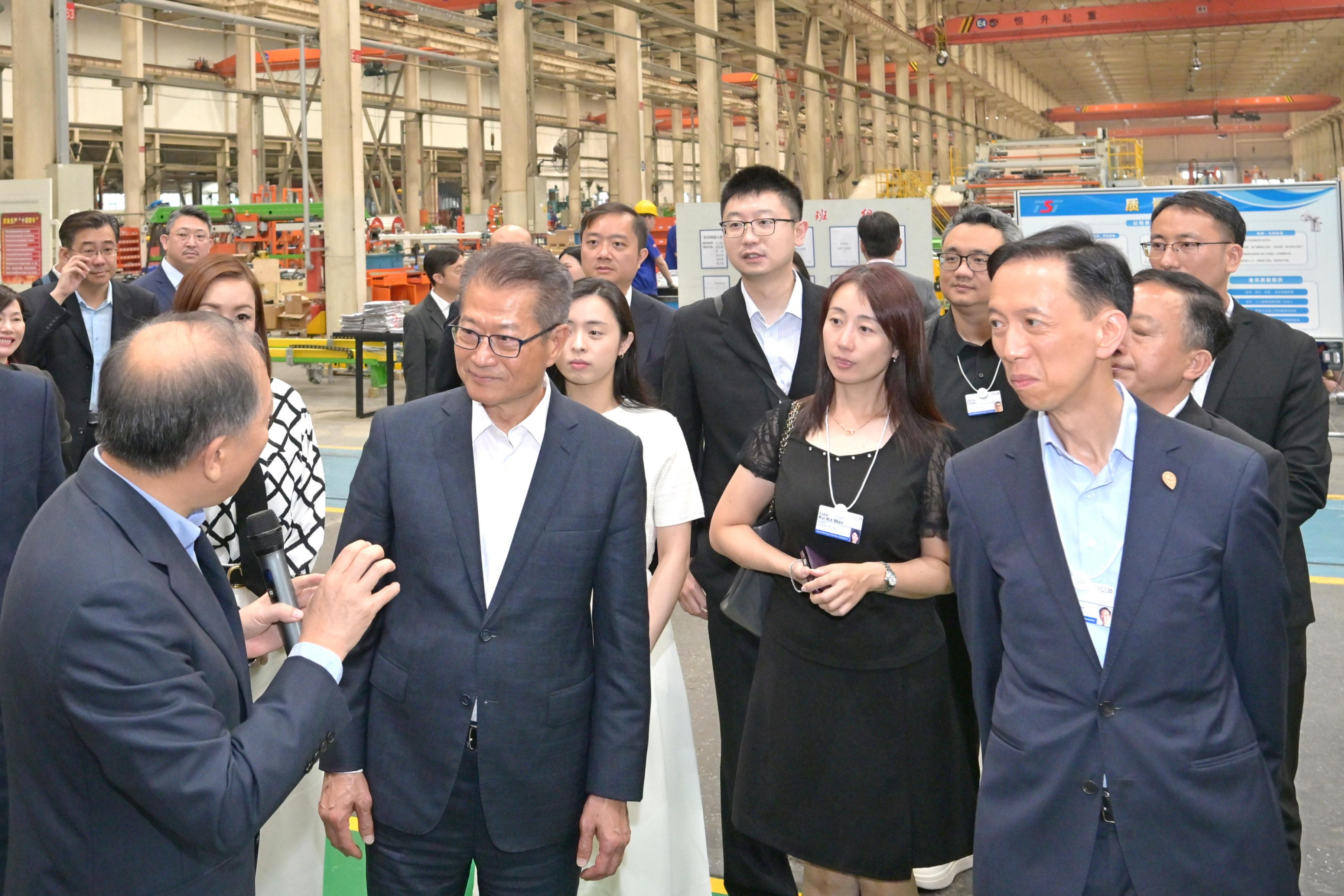 The Financial Secretary, Mr Paul Chan (second left), visited Tianjin today (June 24) and attended the World Economic Forum Annual Meeting of the New Champions 2025 (also known as Summer Davos). Photo shows Mr Chan visiting the Tianjin Binhai High-tech Industrial Development Area and touring an innovative enterprise engaged in advanced equipment manufacturing in the Area. 