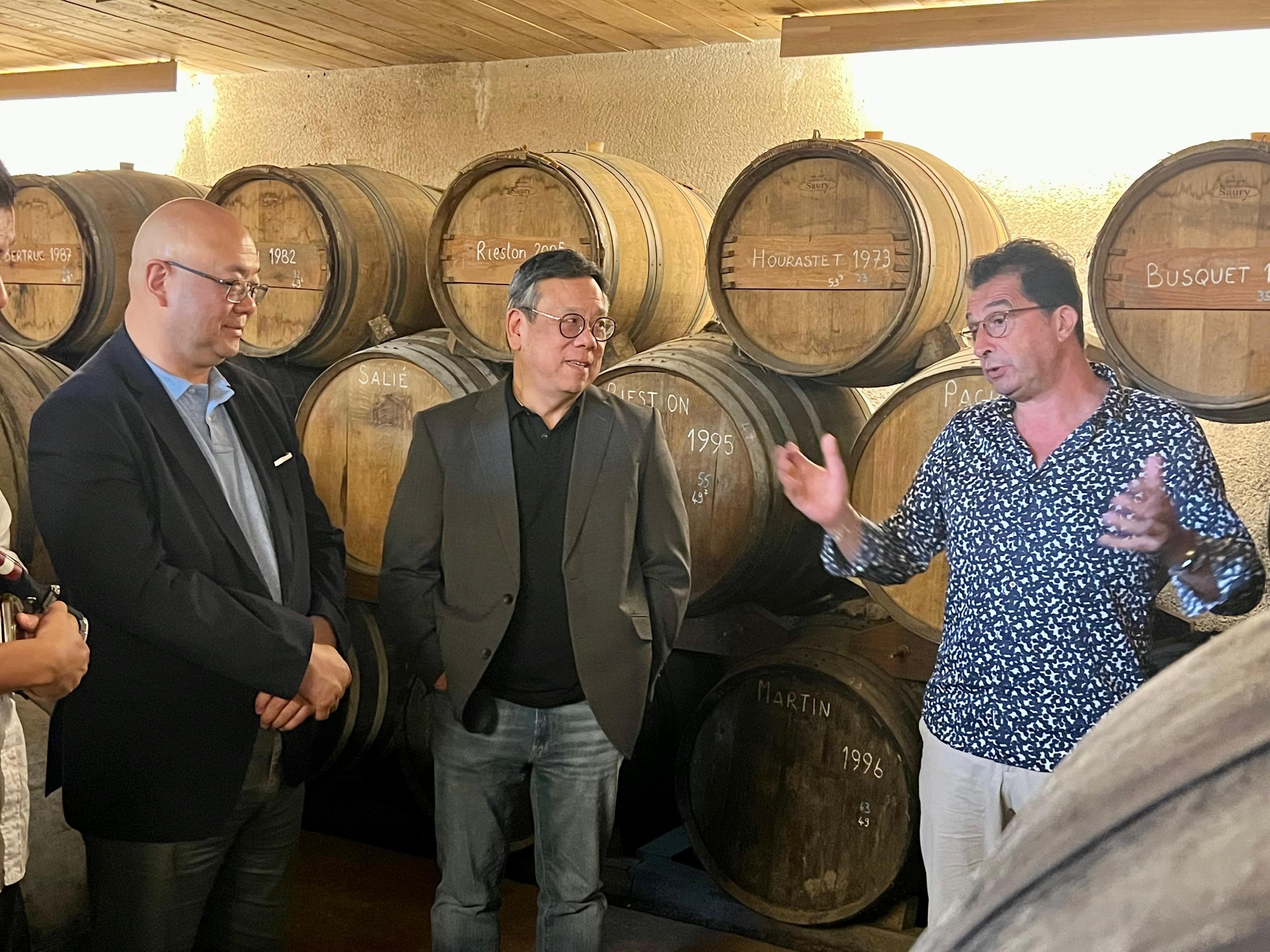 The Secretary for Commerce and Economic Development, Mr Algernon Yau, continued with the last day of his visit to France on June 24 (France time). Photo shows Mr Yau (centre) visiting a wine cellar in Armagnac on June 23 (France time) to learn about its operation. Looking on is Associate Director-General of Investment Promotion Mr Charles Ng (left).