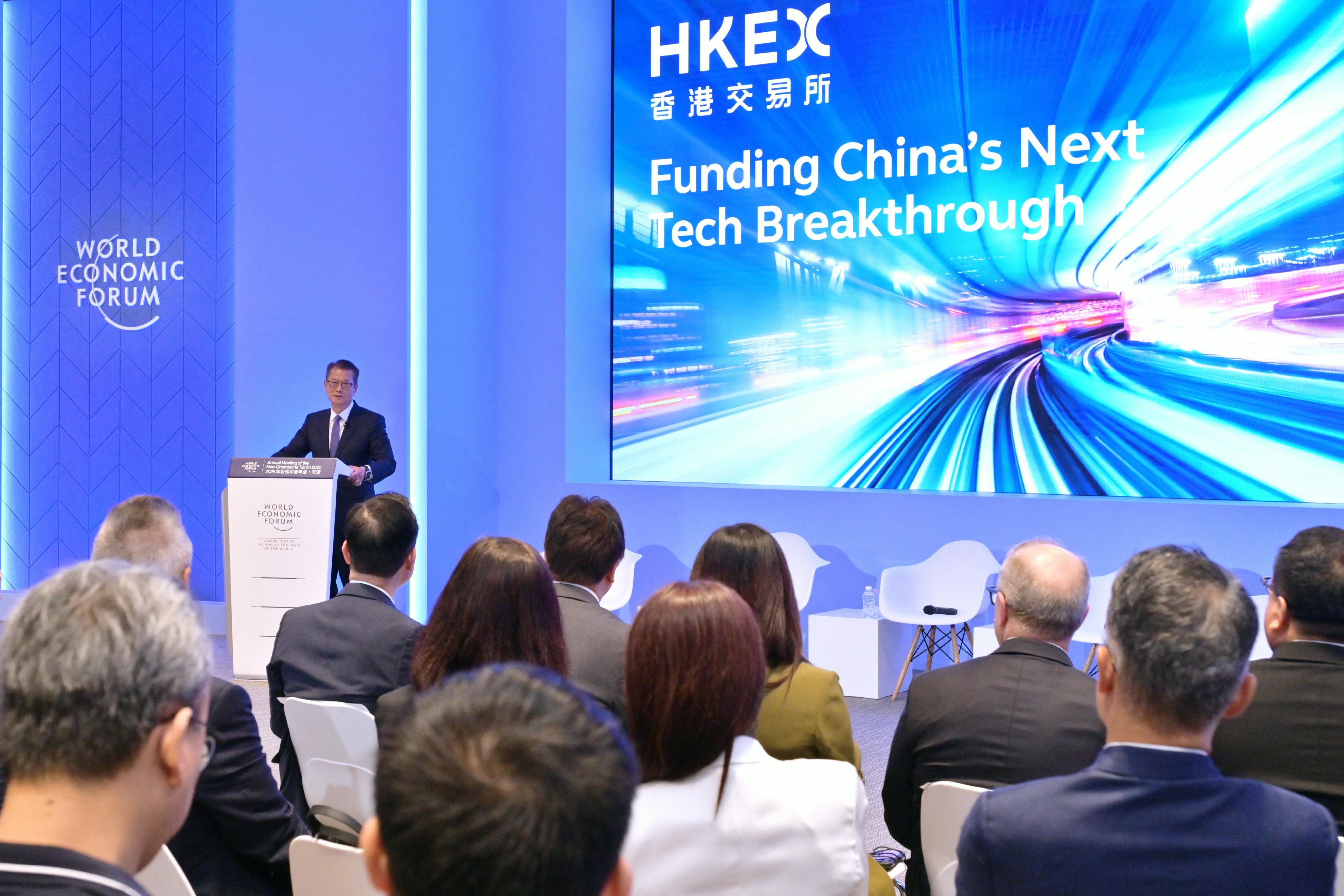 The Financial Secretary, Mr Paul Chan, continued his visit to Tianjin today (June 25) and attended the World Economic Forum Annual Meeting of the New Champions 2025 (also known as Summer Davos). Photo shows Mr Chan speaking at a discussion session titled "Funding China's Next Tech Breakthrough" organised by the Hong Kong Exchanges and Clearing Limited. 