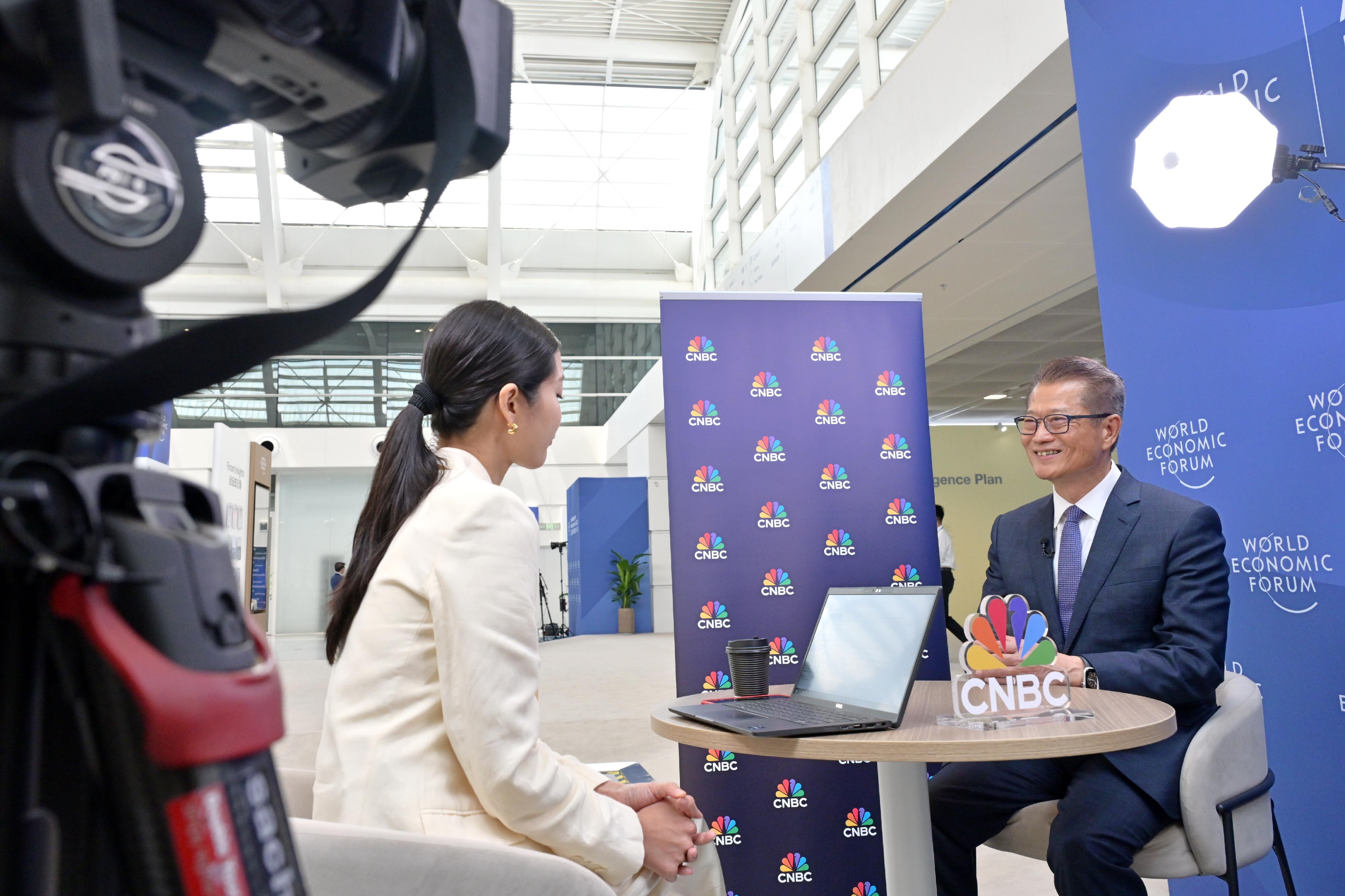 The Financial Secretary, Mr Paul Chan, continued his visit to Tianjin today (June 25) and attended the World Economic Forum Annual Meeting of the New Champions 2025 (also known as Summer Davos). Photo shows Mr Chan (right) being interviewed by an international media agency.  
