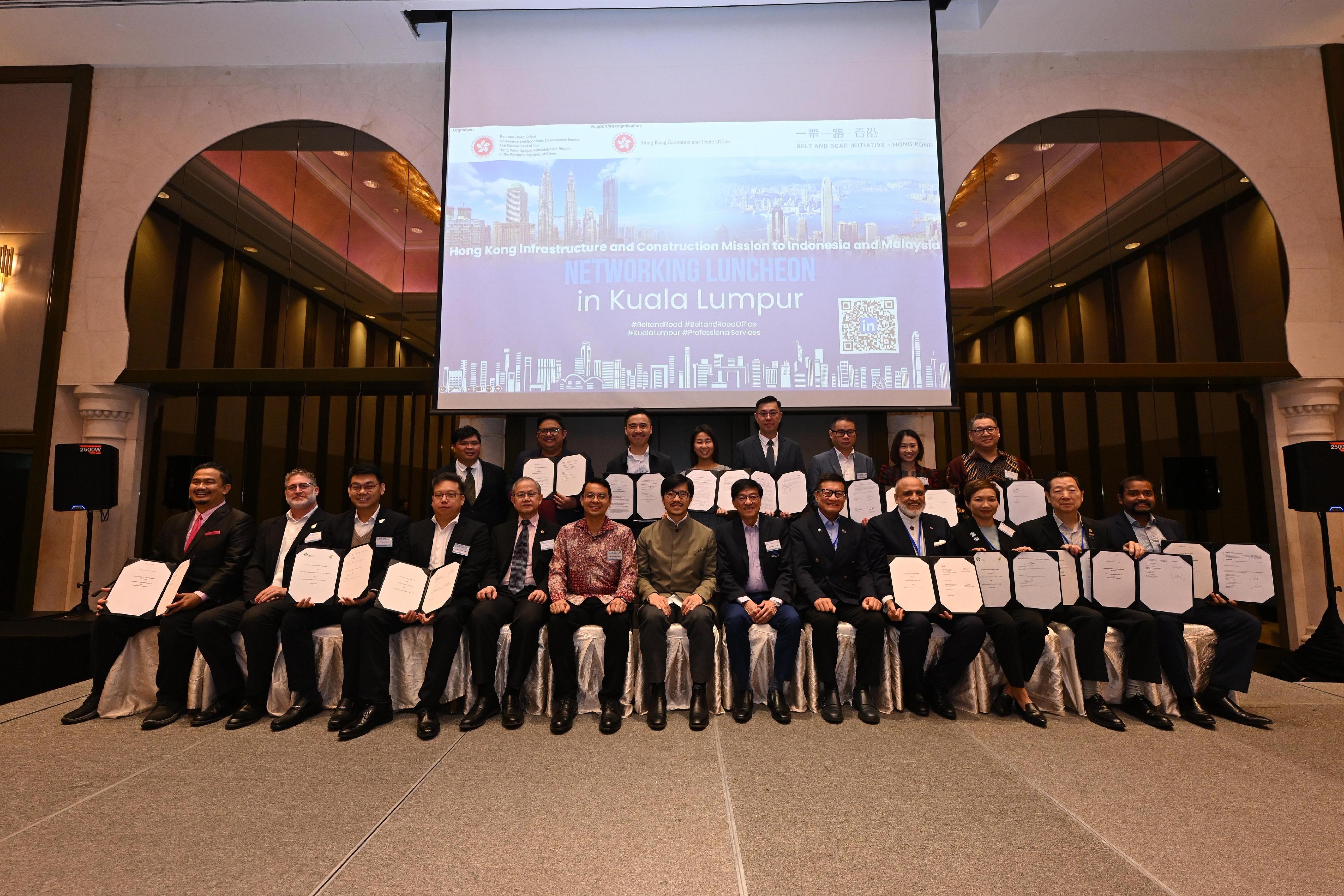 During the visit of a delegation led by the Commissioner for Belt and Road, Mr Nicholas Ho, to Indonesia and Malaysia from June 22 to 26, members of the delegation and representatives from Hong Kong enterprises and organisations signed 21 Memoranda of Understanding (MOU) with their local partners. Photo shows Mr Ho (front row, centre) with the MOU signatories in Kuala Lumpur on June 26.

