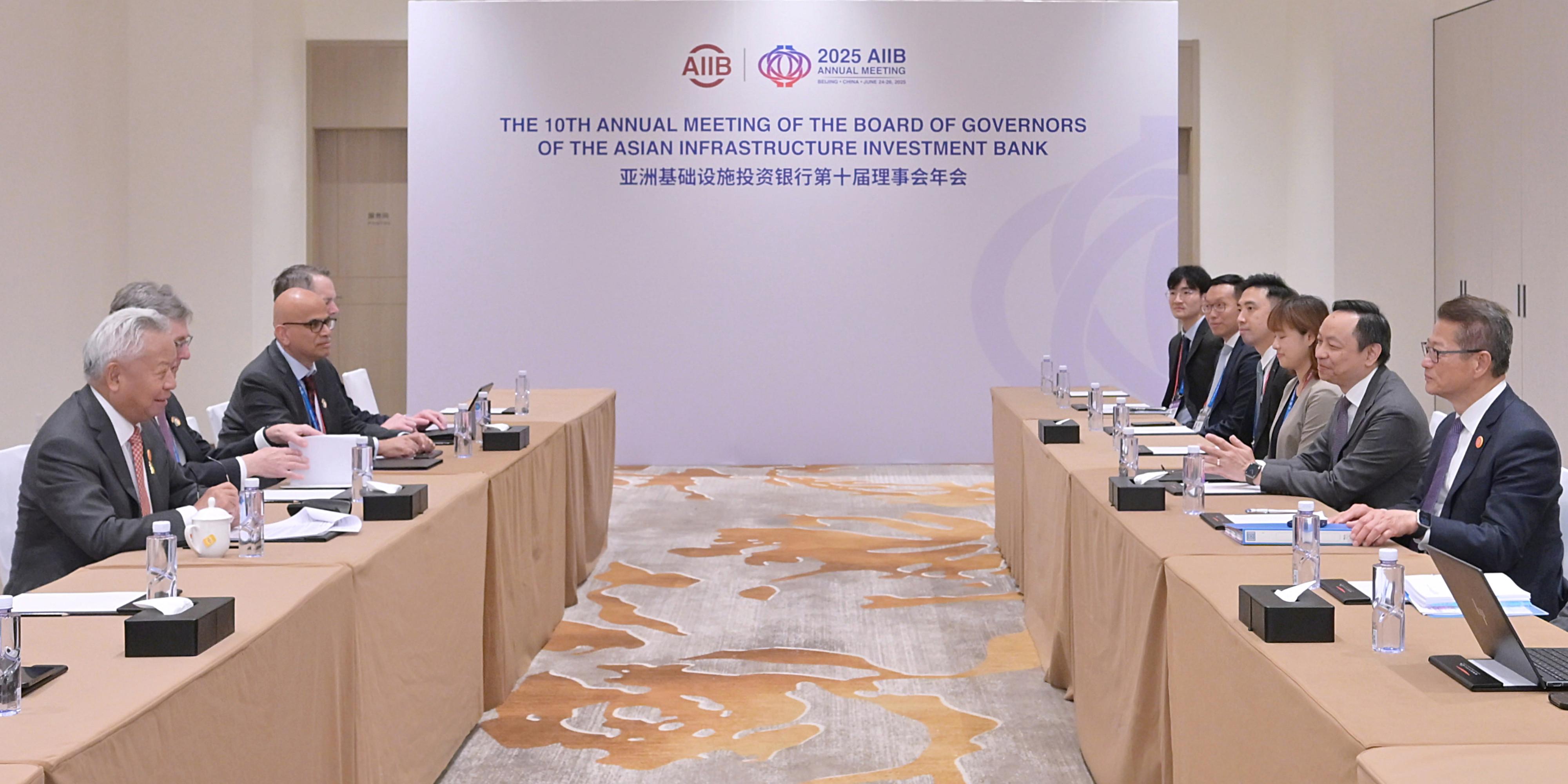 The Financial Secretary, Mr Paul Chan, attended the 10th Annual Meeting of the Board of Governors of the Asian Infrastructure Investment Bank (AIIB) in Beijing today (June 26). Photo shows Mr Chan (first right) meeting with the President of the AIIB, Mr Jin Liqun (first left).