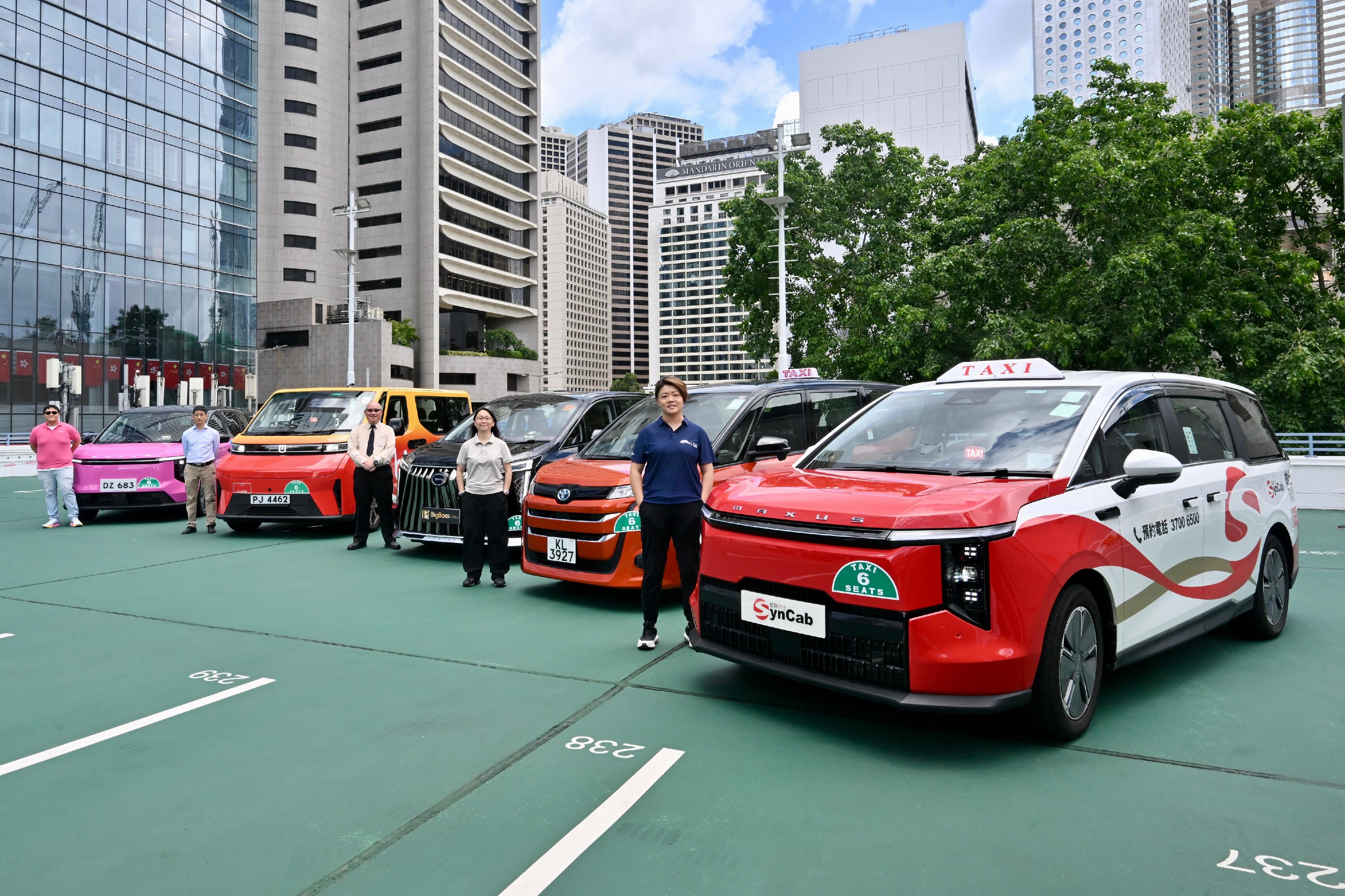 The Transport Department said today (June 27) that official Taxi Fleet Licences are scheduled to be issued to the five taxi fleets in July to offer quality taxi services to the public. Photo shows representatives of the taxi fleet operators and their fleet taxis.