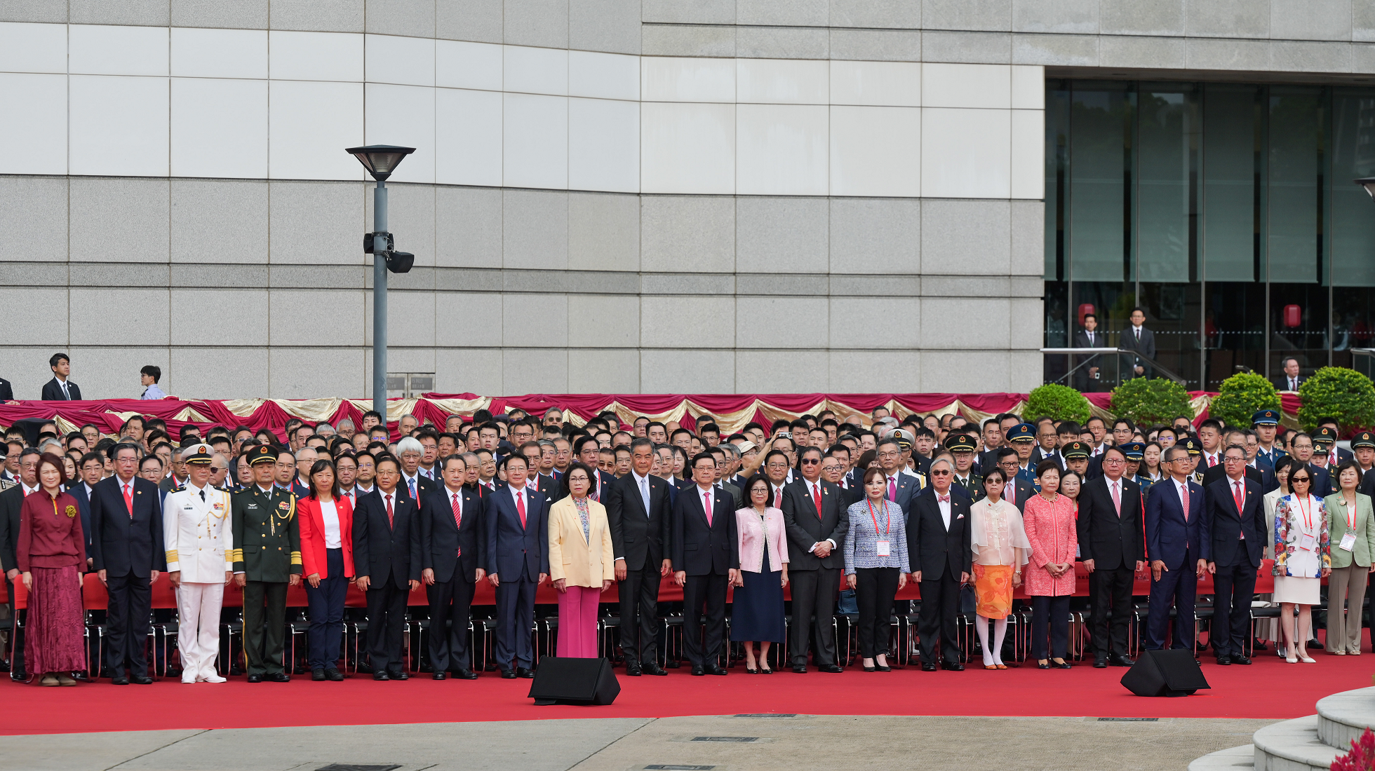 The Chief Executive, Mr John Lee (front row, centre), and his wife (front row, 10th right); the Acting Chief Justice of the Court of Final Appeal, Mr Justice Roberto Ribeiro (front row, 9th right), and his wife (front row, 8th right); former CE Mr Donald Tsang (front row, 7th right), and his wife (front row, 6th right); Vice-Chairman of the National Committee of the CPPCC Mr C Y Leung (front row, 10th left), and his wife (front row, 9th left); former CE Mrs Carrie Lam (front row, 5th right); the Director of the LOCPG in the HKSAR, Mr Zhou Ji (front row, 8th left); the Head of the Office for Safeguarding National Security of the CPG in the HKSAR, Mr Dong Jingwei (front row, 7th left); the Commissioner of the Ministry of Foreign Affairs in the HKSAR, Mr Cui Jianchun (front row, 6th left), and his wife (front row, 5th left); the Commander-in-chief of the CPLA Hong Kong Garrison, Major General Peng Jingtang (front row, 4th left); the Political Commissar of the CPLA Hong Kong Garrison, Navy Rear Admiral Lai Ruxin (front row, 3rd left); the Chief Secretary for Administration, Mr Chan Kwok-ki (front row, 4th right); the Financial Secretary, Mr Paul Chan (front row, 3rd right); the Secretary for Justice, Mr Paul Lam, SC (front row, 2nd right); the President of LC, Mr Andrew Leung (front row, 2nd left); the Convenor of the Non-official Members of ExCo, Mrs Regina Ip (front row, 1st right), together with Principal Officials and guests, attend the flag-raising ceremony for the 28th anniversary of the establishment of the HKSAR at Golden Bauhinia Square in Wan Chai today (July 1).