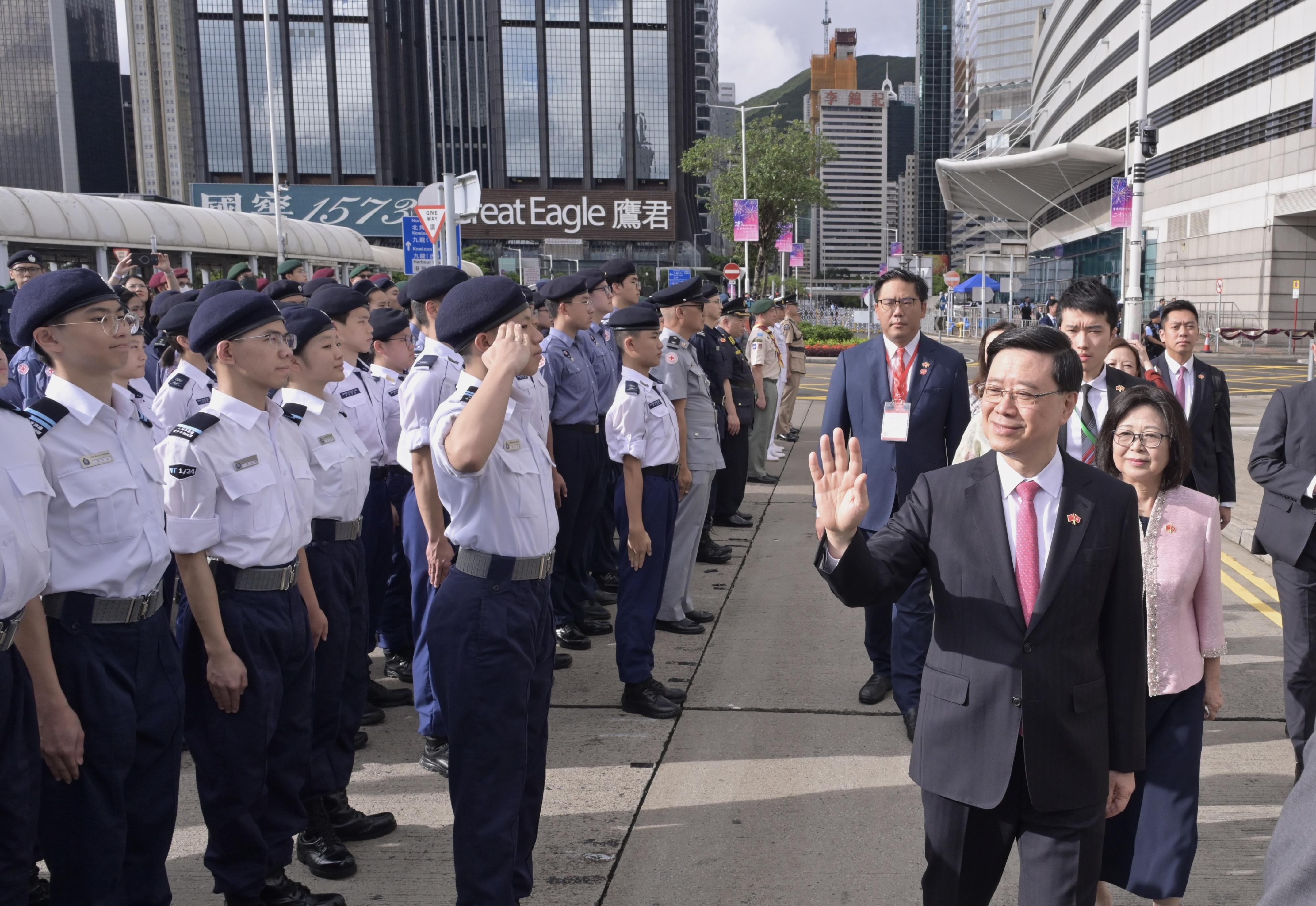 The Chief Executive, Mr John Lee, together with Principal Officials and guests, attended the flag-raising ceremony for the 28th anniversary of the establishment of the Hong Kong Special Administrative Region at Golden Bauhinia Square in Wan Chai this morning (July 1). Photo shows Mr Lee (second right) receiving salute by uniformed groups.