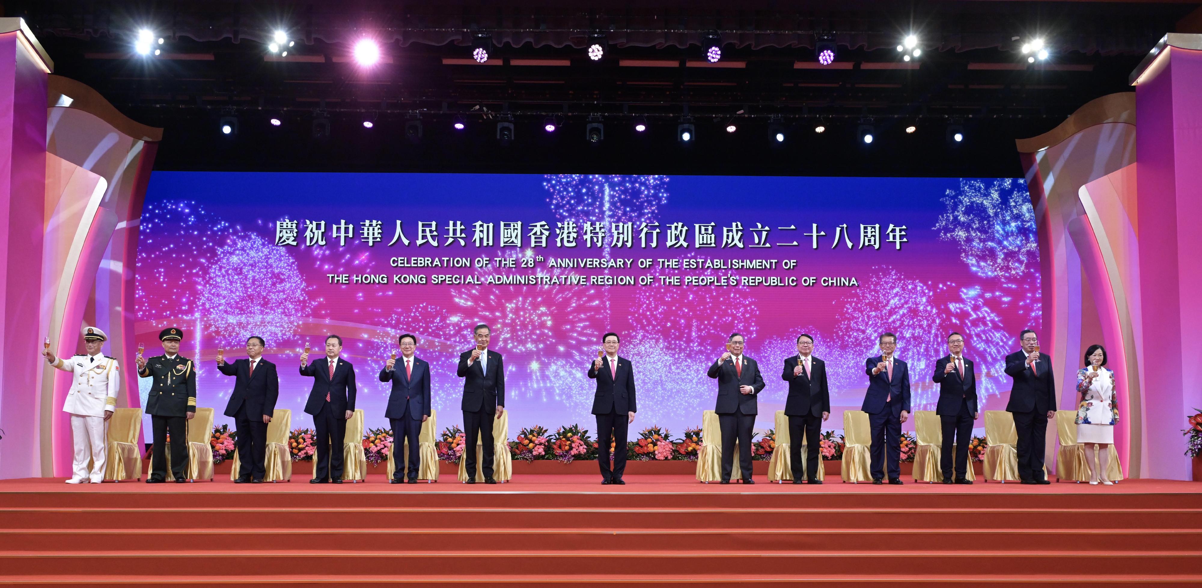 The Chief Executive, Mr John Lee, together with Principal Officials and guests, attended the reception for the 28th anniversary of the establishment of the Hong Kong Special Administrative Region (HKSAR) at the Hong Kong Convention and Exhibition Centre this morning (July 1). Photo shows (from left) the Political Commissar of the Chinese People's Liberation Army Hong Kong Garrison, Navy Rear Admiral Lai Ruxin; the Commander-in-chief of the Chinese People's Liberation Army Hong Kong Garrison, Major General Peng Jingtang; the Commissioner of the Ministry of Foreign Affairs in the HKSAR, Mr Cui Jianchun; the Head of the Office for Safeguarding National Security of the Central People's Government in the HKSAR, Mr Dong Jingwei; the Director of the Liaison Office of the Central People's Government in the HKSAR, Mr Zhou Ji; Vice-Chairman of the National Committee of the Chinese People's Political Consultative Conference Mr C Y Leung; Mr Lee; the Acting Chief Justice of the Court of Final Appeal, Mr Justice Roberto Ribeiro; the Chief Secretary for Administration, Mr Chan Kwok-ki; the Financial Secretary, Mr Paul Chan; the Secretary for Justice, Mr Paul Lam, SC; the President of the Legislative Council, Mr Andrew Leung; and the Convenor of the Non-official Members of the Executive Council, Mrs Regina Ip, proposing a toast.
