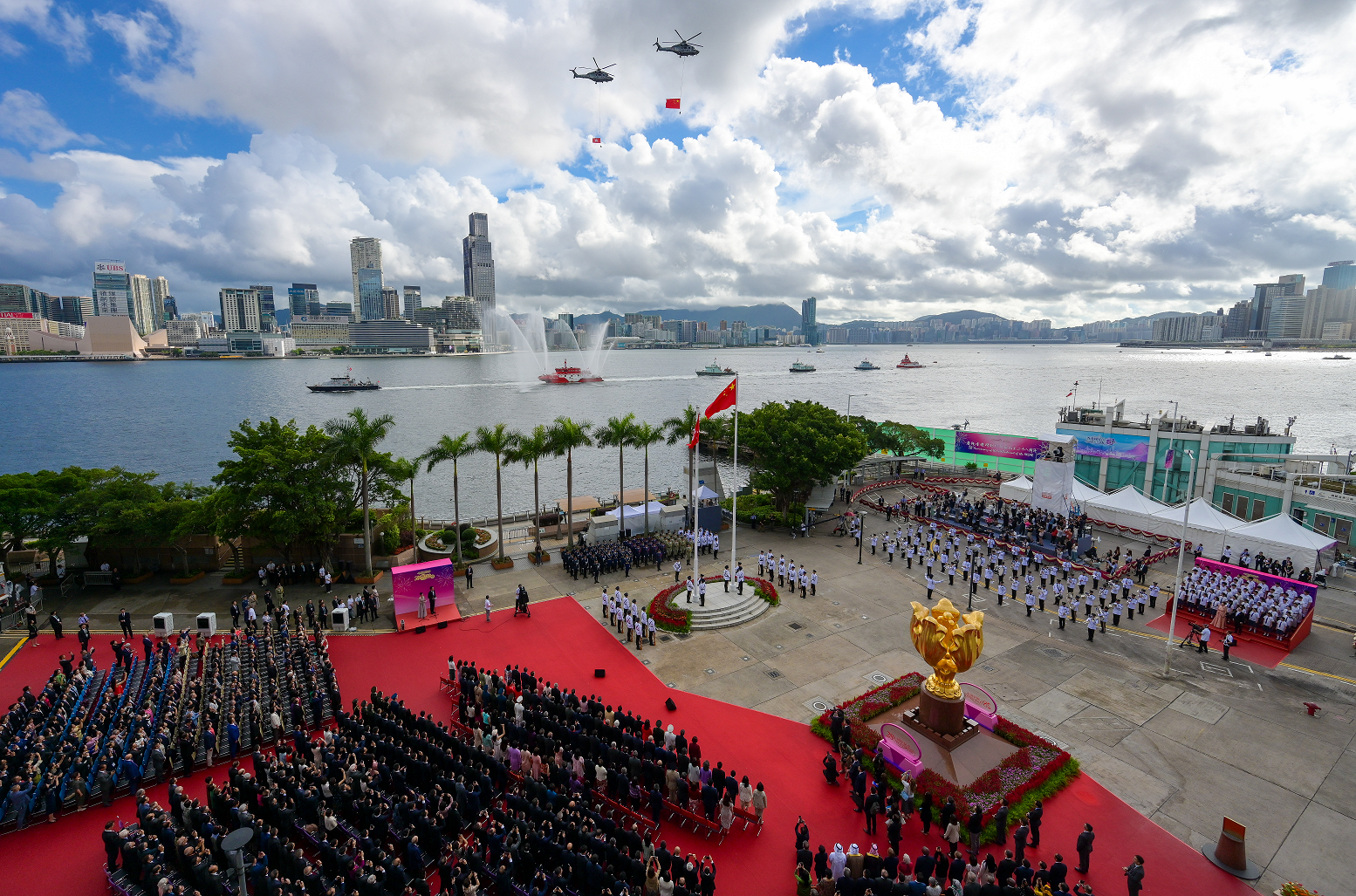 The disciplined services and the Government Flying Service perform a sea parade and a fly-past to mark the 28th anniversary of the establishment of the Hong Kong Special Administrative Region at the flag-raising ceremony at Golden Bauhinia Square in Wan Chai this morning (July 1).

