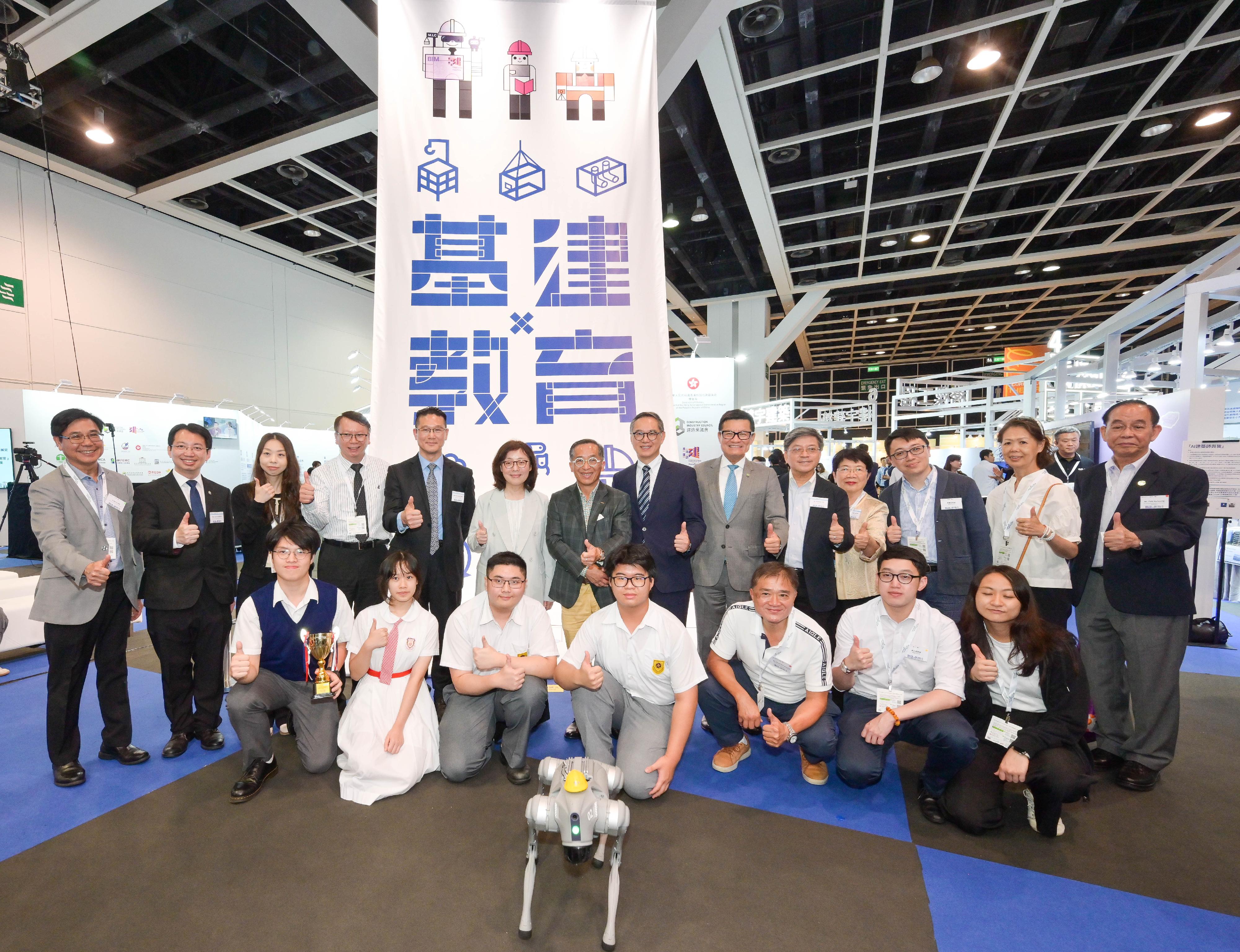 The launching ceremony of the Infrastructure x Education Exhibition and the first phase of achievement of the STEAM UP project, jointly organised by the Development Bureau and the Construction Industry Council (CIC), was held today (July 3). Photo shows the Secretary for Development, Ms Bernadette Linn (back row, sixth left); the Permanent Secretary for Development (Works), Mr Ricky Lau (back row, seventh right); the Chairman of the CIC, Professor Thomas Ho (back row, seventh left); and the Executive Director of the CIC, Mr Albert Cheng (back row, sixth right), with the other guests and students.