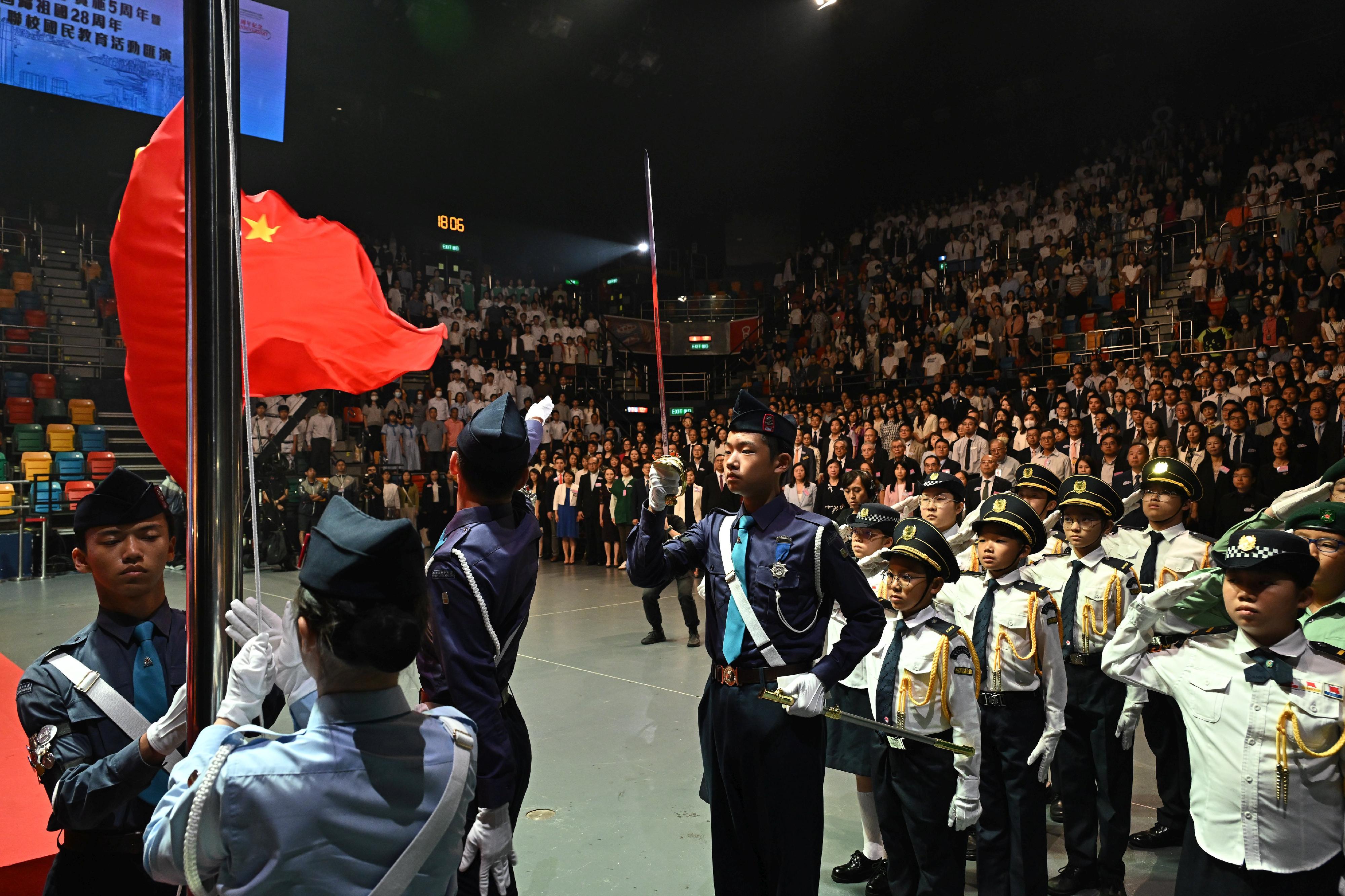 The Education Bureau today (July 4) held the "Love Our Home, Treasure Our Country" Joint School National Education Activities Gala in celebration of the fifth anniversary of the implementation of the Hong Kong National Security Law and the 28th anniversary of Hong Kong's return to the motherland. Photo shows guests and students singing the national anthem and viewing the raising of the national flag at the ceremony.