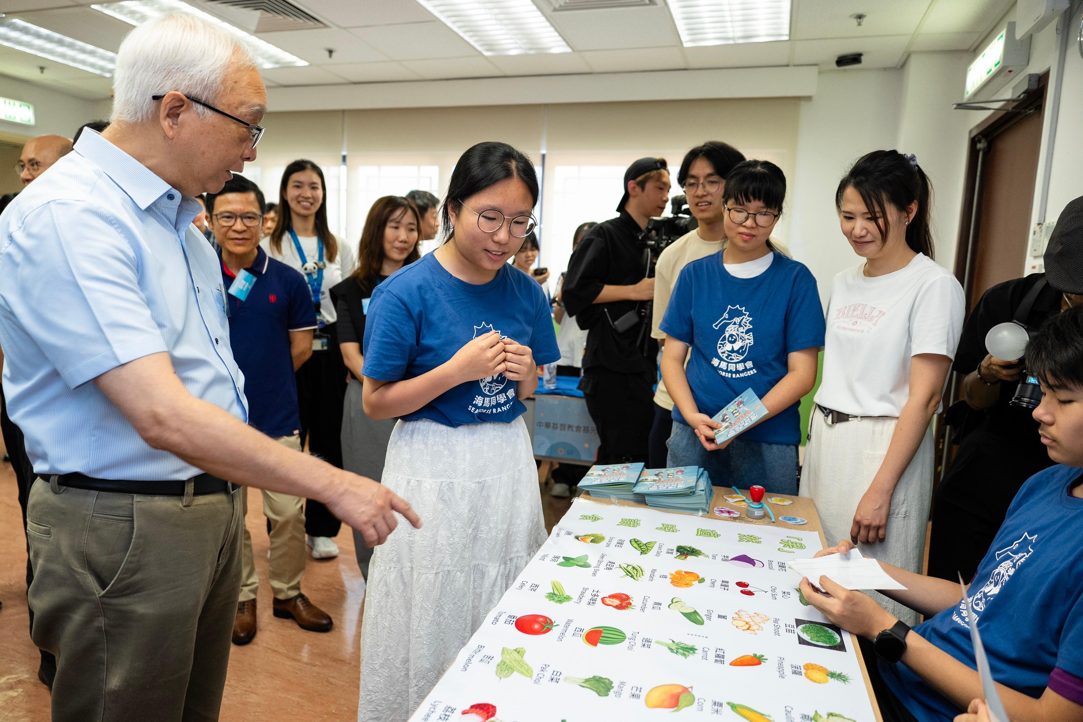 The SGREEN x We-recycle@School Competitions Award Ceremony, co-organised by the Environmental Protection Department and Ocean Park Hong Kong (Ocean Park), was held today (July 5) at Ocean Park to commend schools, students and families for their outstanding performance in waste reduction and recycling during the 2024/25 school year. Photo shows the Secretary for Environment and Ecology, Mr Tse Chin-wan (first left), touring the school booths.