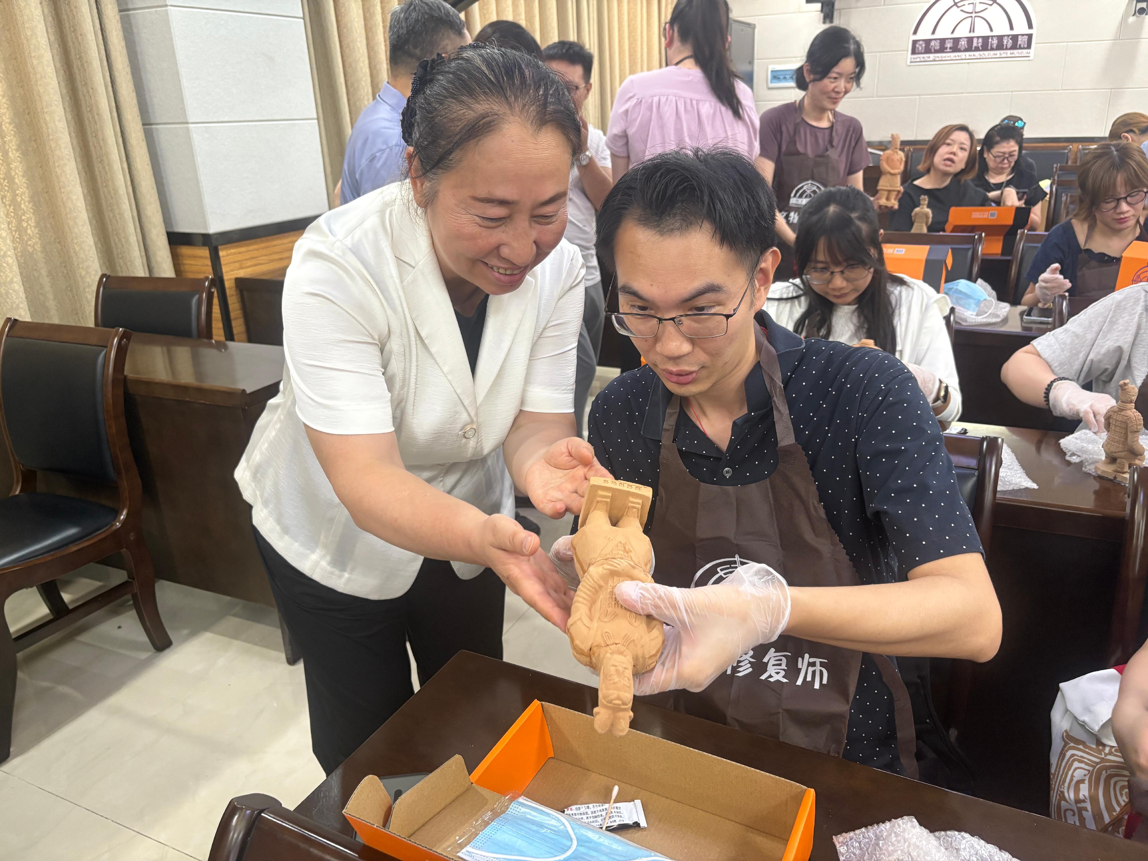 The teacher study tour to Shaanxi on the ancient civilisation of the Qin and Han dynasties, co-organised by the Chinese Culture Promotion Office of the Leisure and Cultural Services Department and the Education Bureau, led 23 secondary school Chinese history teachers to visit various major museums and cultural institutions in Xi'an from June 27 to July 1. Photo shows teachers participating in the terracotta warrior restoration workshop at the Emperor Qinshihuang's Mausoleum Site Museum to experience the restoration process of terracotta warrior models, and understand the craftsmanship and historical significance.