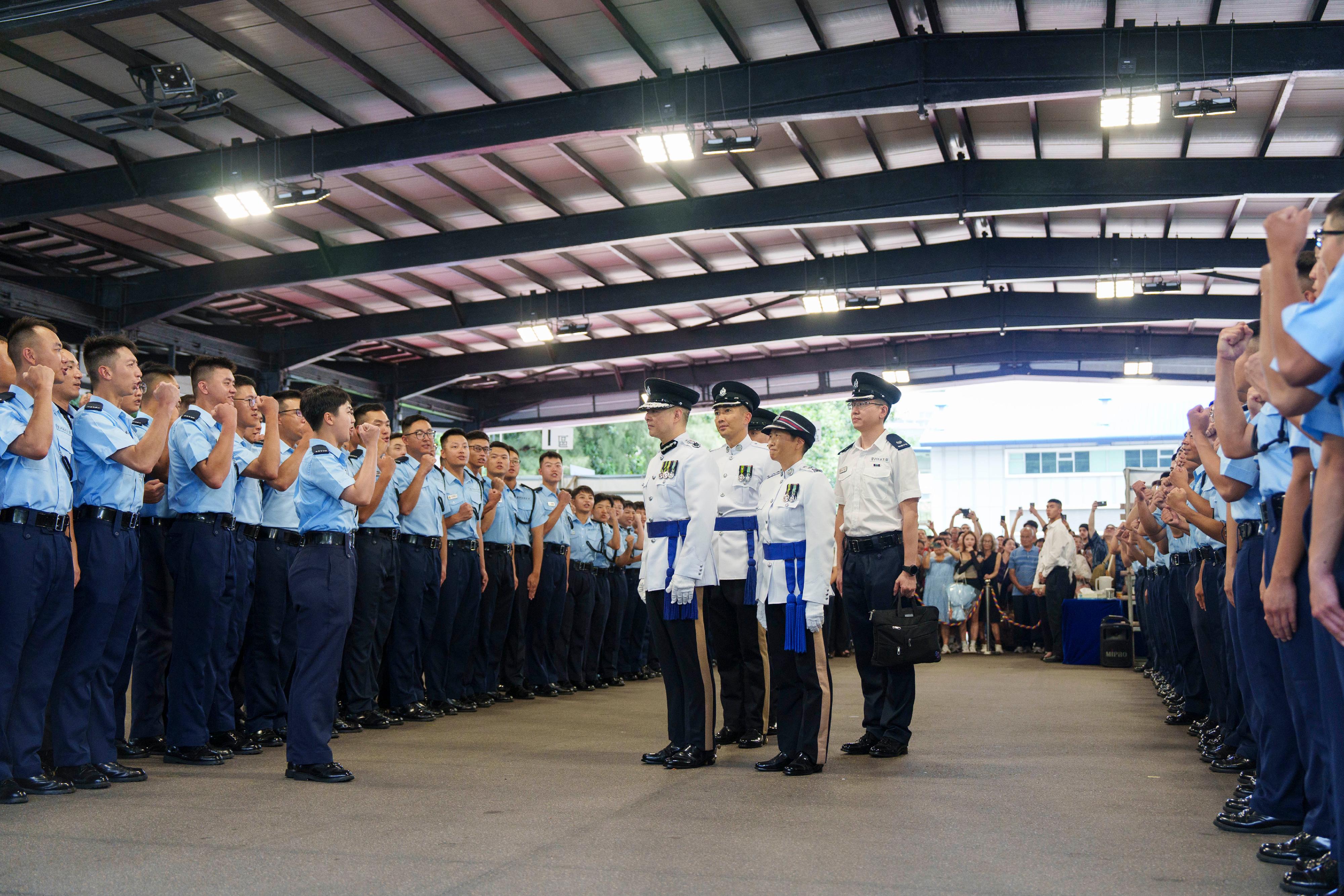 The Commissioner of Police, Mr Chow Yat-ming (fourth right), meets graduates after the passing-out parade held at the Hong Kong Police College today (July 12).
