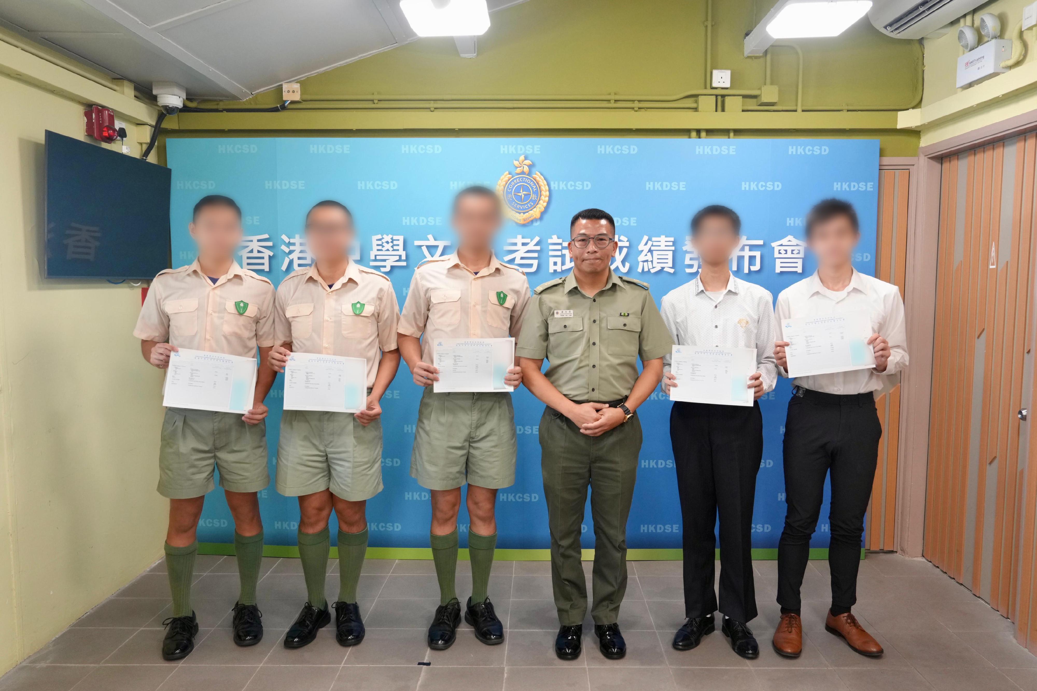 香港中學文憑考試成績今日（七月十六日）公布，今年共有20名青少年在囚人士報考。圖示沙咀懲教所監督潘浩霖（右三）頒發成績通知書予在囚人士及更生人士。