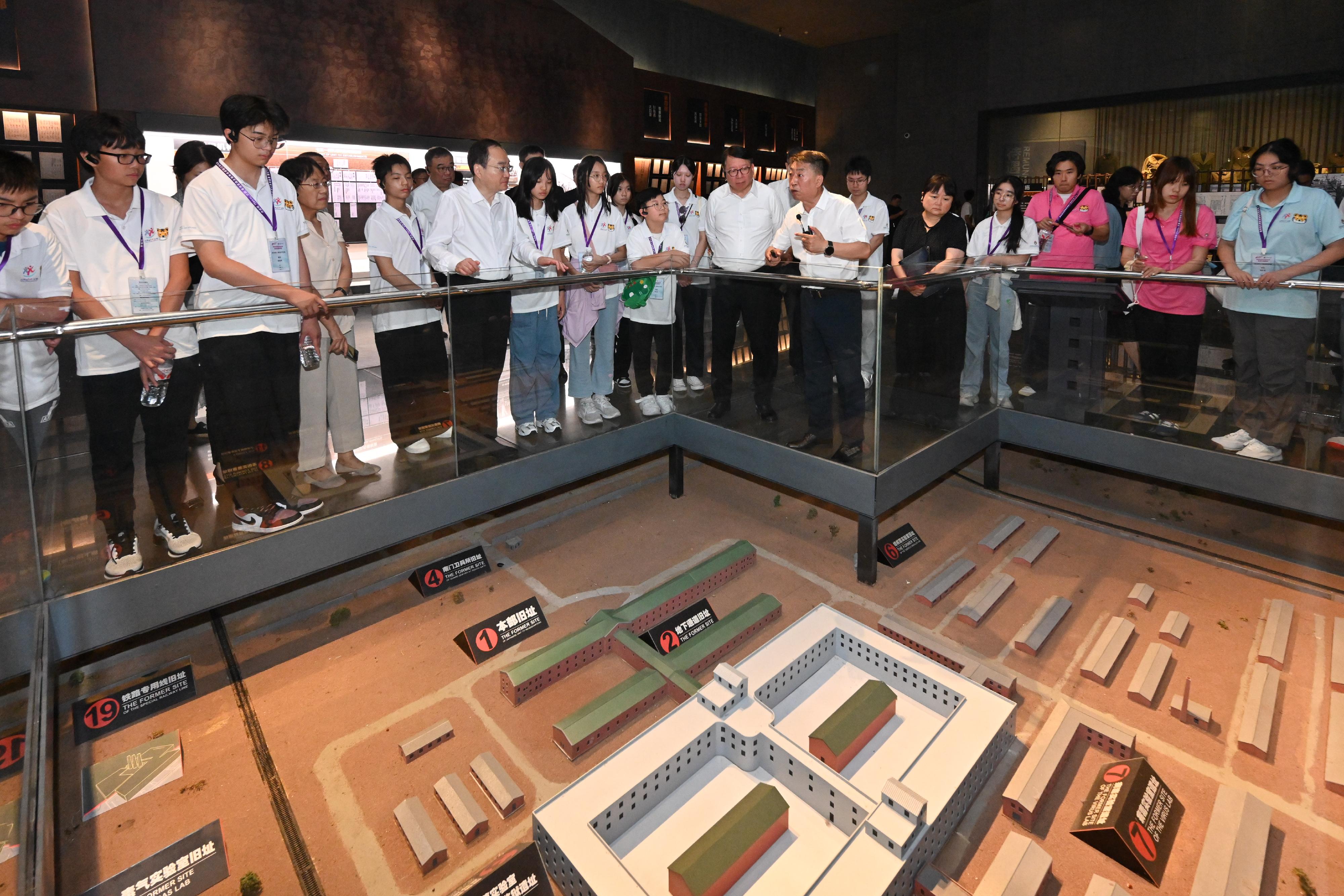 The Chief Secretary for Administration, Mr Chan Kwok-ki, continued his visit to Heilongjiang Province today (July 16). Photo shows Mr Chan (ninth right) and members of the Hong Kong Patriotic Education Heilongjiang Study Tour under the Strive and Rise Programme visiting the Exhibition Hall of Evidences of Crime Committed by Unit 731 of the Japanese Imperial Army, and being briefed by a staff member.
