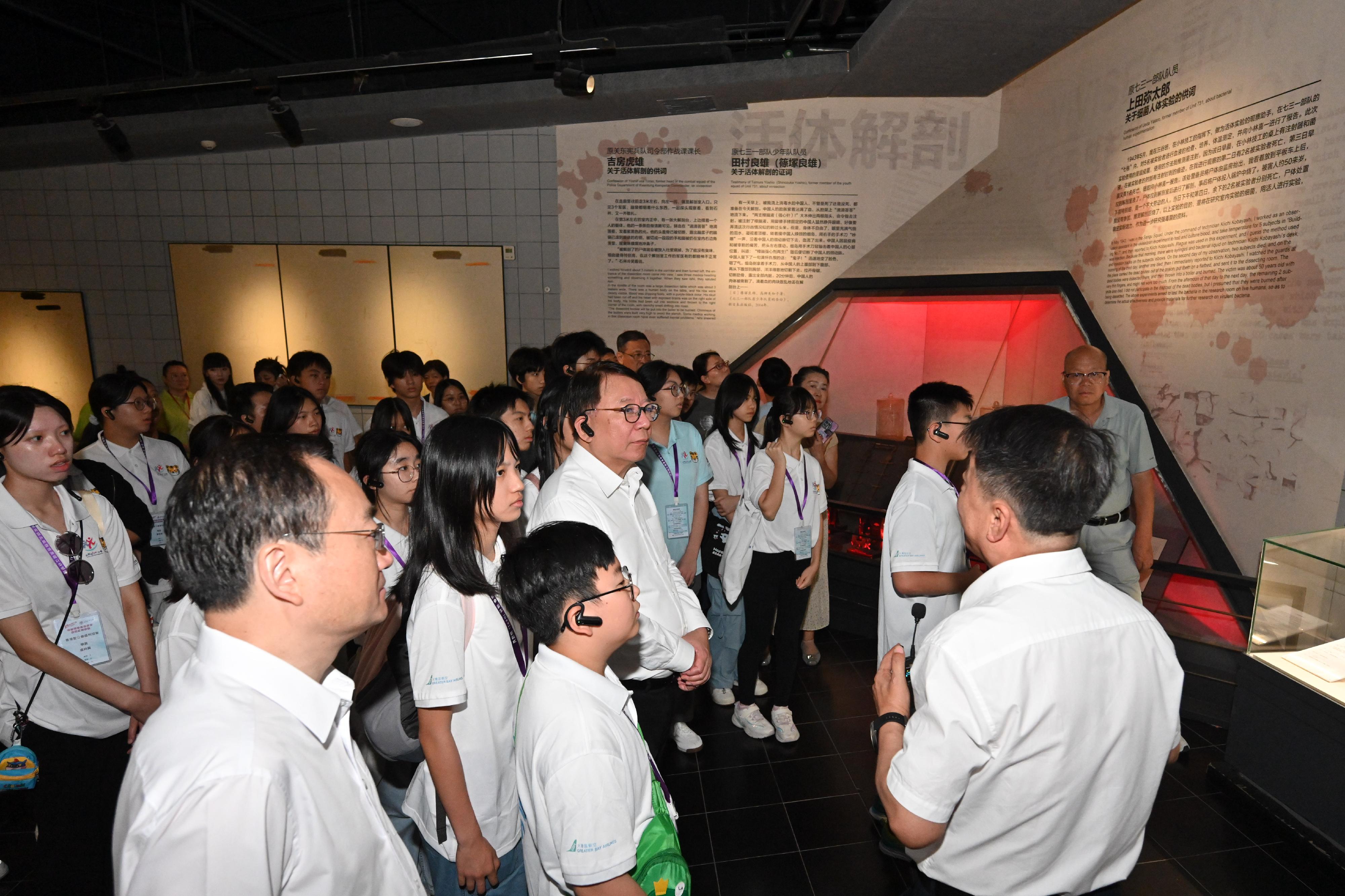 The Chief Secretary for Administration, Mr Chan Kwok-ki, continued his visit to Heilongjiang Province today (July 16). Photo shows Mr Chan (front row, fourth left) and members of the Hong Kong Patriotic Education Heilongjiang Study Tour under the Strive and Rise Programme visiting the Exhibition Hall of Evidences of Crime Committed by Unit 731 of the Japanese Imperial Army, and being briefed by a staff member.