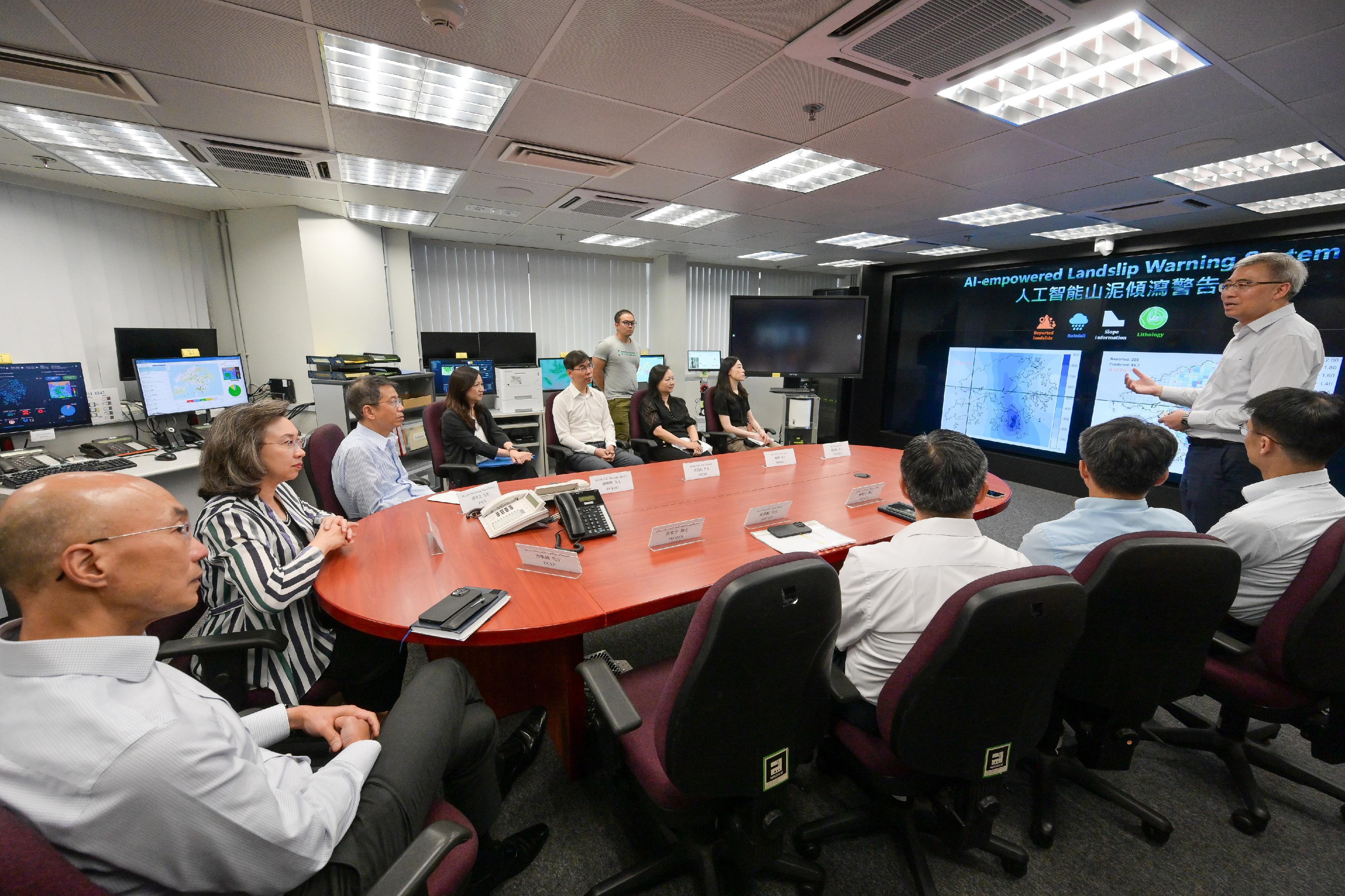 The Secretary for the Civil Service, Mrs Ingrid Yeung, visited the Civil Engineering and Development Department this afternoon (July 18) to learn about the department's latest progress in optimising operational efficiency and services through the application of technology, as well as its work in landslip prevention and mitigation and slope safety. Photo shows Mrs Yeung (second left) being briefed by the Head of the Geotechnical Engineering Office, Dr Raymond Cheung (first right), on the in-house developed, AI-empowered Landslip Warning System on trial run this year. Looking on are the Permanent Secretary for the Civil Service, Mr Clement Leung (third left), and the Director of Civil Engineering and Development, Mr Michael Fong (first left).