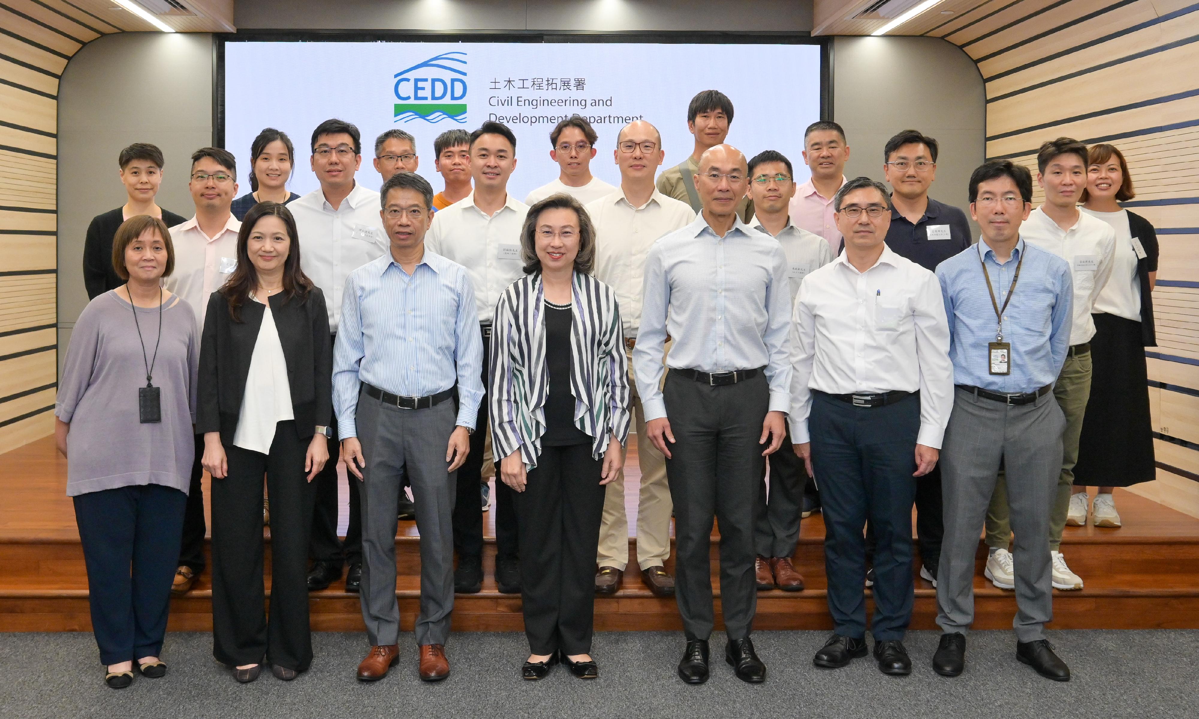 The Secretary for the Civil Service, Mrs Ingrid Yeung, visited the Civil Engineering and Development Department this afternoon (July 18) to learn about the department's latest progress in optimising operational efficiency and services through the application of technology, as well as its work in landslip prevention and mitigation and slope safety. Photo shows Mrs Yeung (front row, centre); the Permanent Secretary for the Civil Service, Mr Clement Leung (front row, third left); and the Director of Civil Engineering and Development, Mr Michael Fong (front row, third right), with staff representatives from various grades in the department.