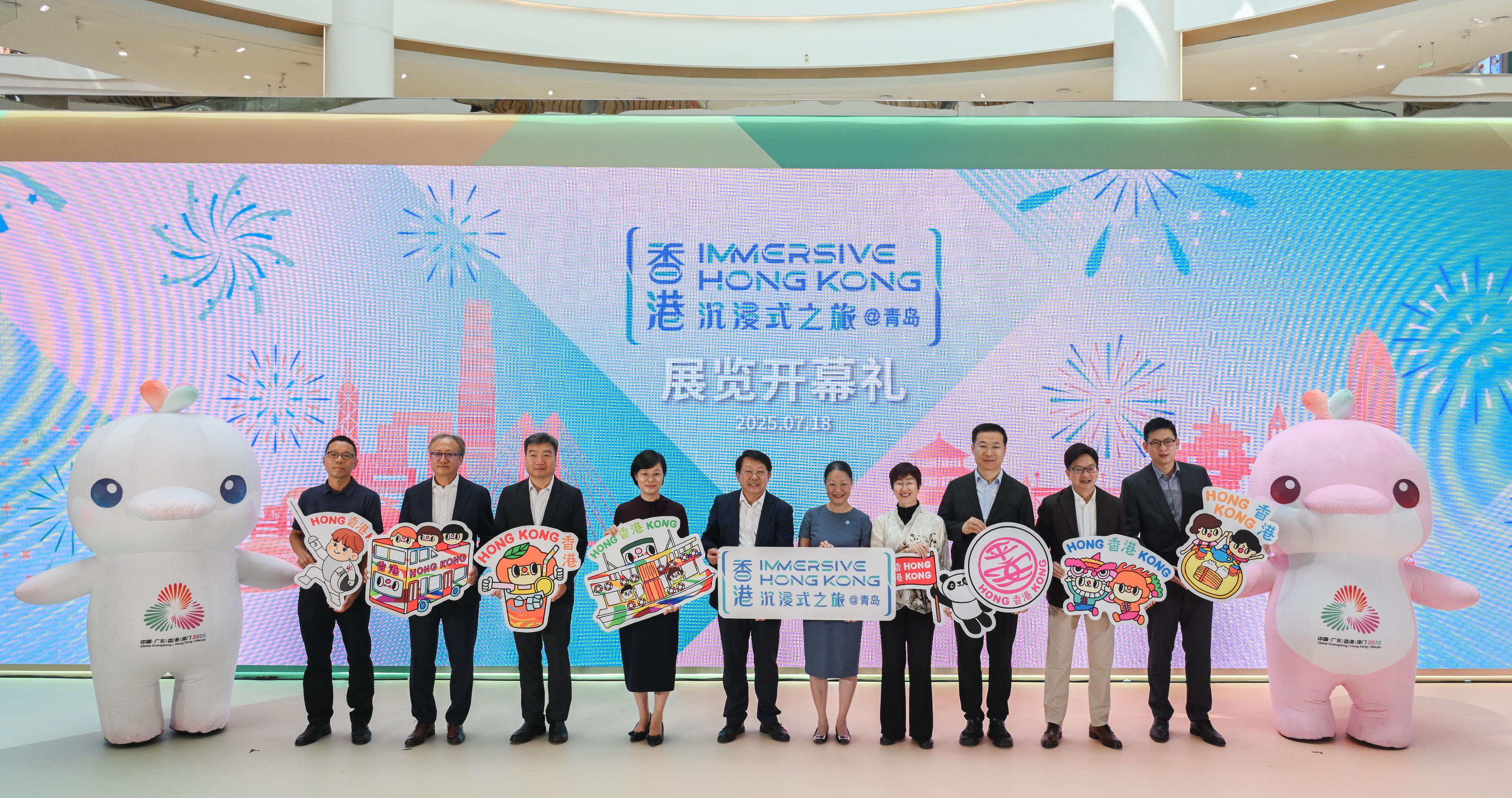 The "Immersive Hong Kong" roving exhibition, which showcases the diversity and latest developments of Hong Kong through interactive art technology, opened in Qingdao today (July 18). The exhibition invites visitors from Qingdao and the entire Shandong Province to explore the unique opportunities and potential for tourism, education, business and investment in Hong Kong. Photo shows (from left) the Vice President of the Laoshan Sub-council of the China Council for the Promotion of International Trade, Mr Liu Wenfeng; the Director Shandong of the Hong Kong Trade Development Council, Mr Patrick Kuang; the Director of the Culture and Tourism Bureau of Qingdao, Mr Pan Feng; Vice Mayor of the Qingdao Municipal People's Government Ms Zhao Yan; the Director of the Hong Kong and Macao Affairs Office of Shandong Provincial People's Government, Mr Zhang Liansan; the Director of Information Services, Mrs Apollonia Liu; the Director of the Hong Kong Economic and Trade Office in Shanghai, Mrs Laura Aron; the Director of the Hong Kong and Macao Affairs Office of the Qingdao Municipal People's Government, Mr Song Rendeng; the Director of the Shandong Liaison Unit of the Hong Kong Special Administrative Region Government, Mr Gary Wong; and the Deputy General Manager of the Qingdao region of the Lion Mall, Mr Lucas Zhao with mascots for the 15th National Games at the opening ceremony.