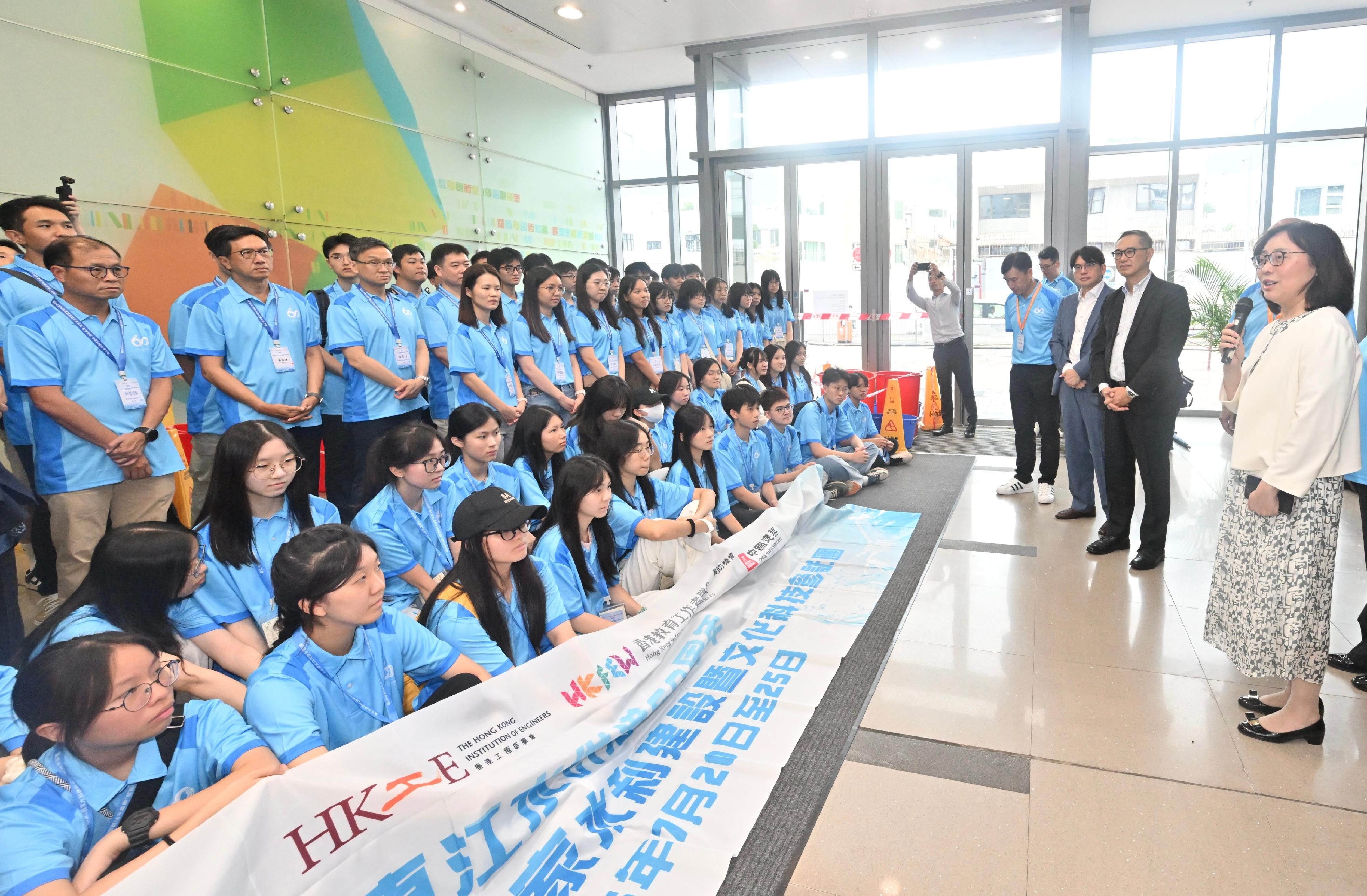 In celebration and commemoration of the 60th anniversary of Dongjiang's water supply to Hong Kong, a study tour on national water infrastructure, culture and technology jointly organised by the Water Supplies Department, the Hong Kong Institution of Engineers and the Hong Kong Federation of Education Workers departed this afternoon (July 21) for Xiangyang, Hubei Province, to begin its itinerary. Photo shows the Secretary for Development, Ms Bernadette Linn (first right); the Permanent Secretary for Development (Works), Mr Ricky Lau (second right); and the Director of Water Supplies, Mr Roger Wong (third right), sharing messages of encouragement with members of the study tour as they saw the group off this afternoon.