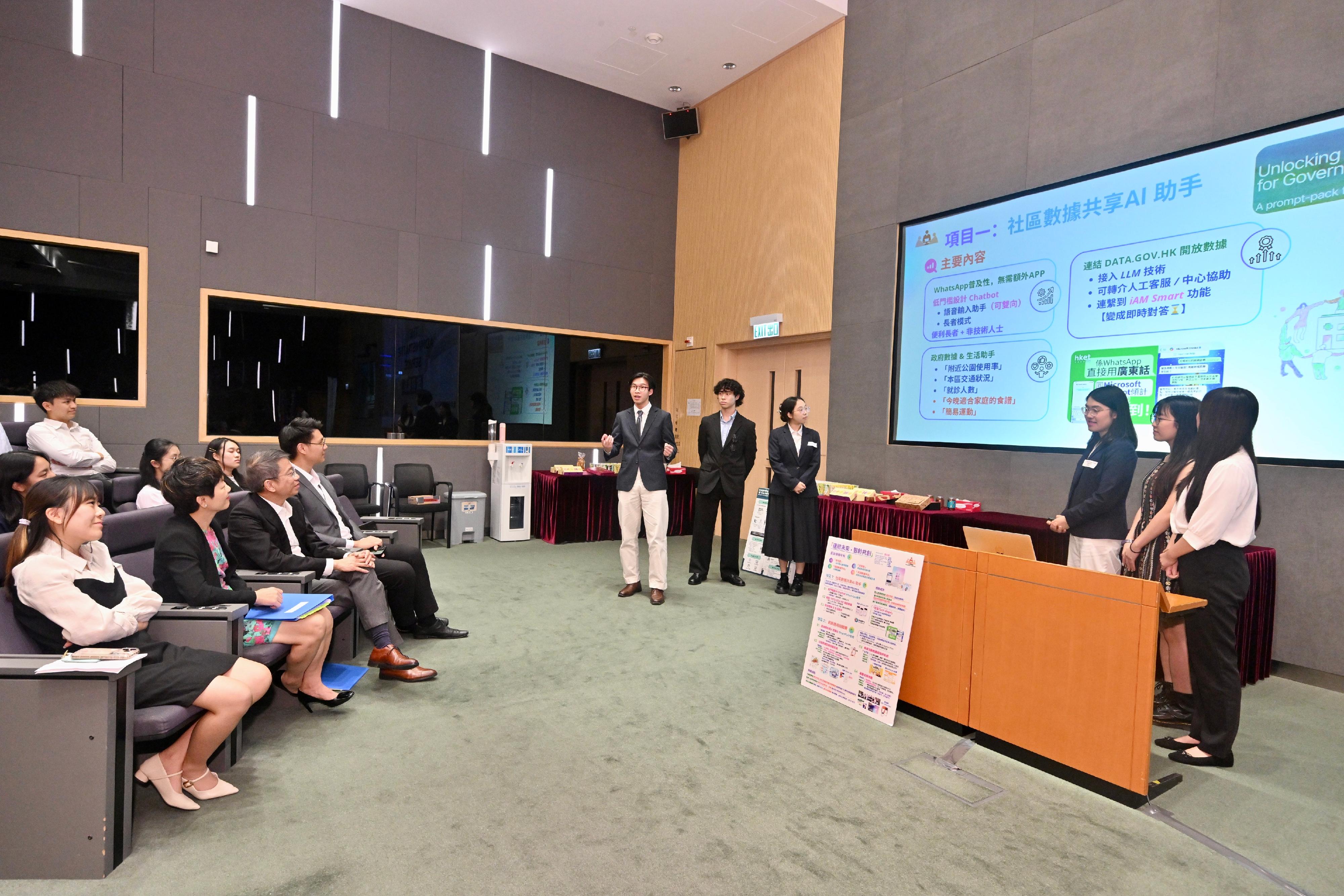 The Secretary for the Civil Service, Mrs Ingrid Yeung, met and shared experiences with over 50 tertiary students participating in the Administrative Service Summer Internship Programme today (July 22).  She encouraged them to apply for civil service positions such as the Administrative Officer post. Photo shows the Permanent Secretary for the Civil Service, Mr Clement Leung (front row, third left), and Deputy Secretary for the Civil Service Ms Eureka Cheung (front row, second left) listening to the interns reporting their policy proposals on district affairs, community data sharing, etc.