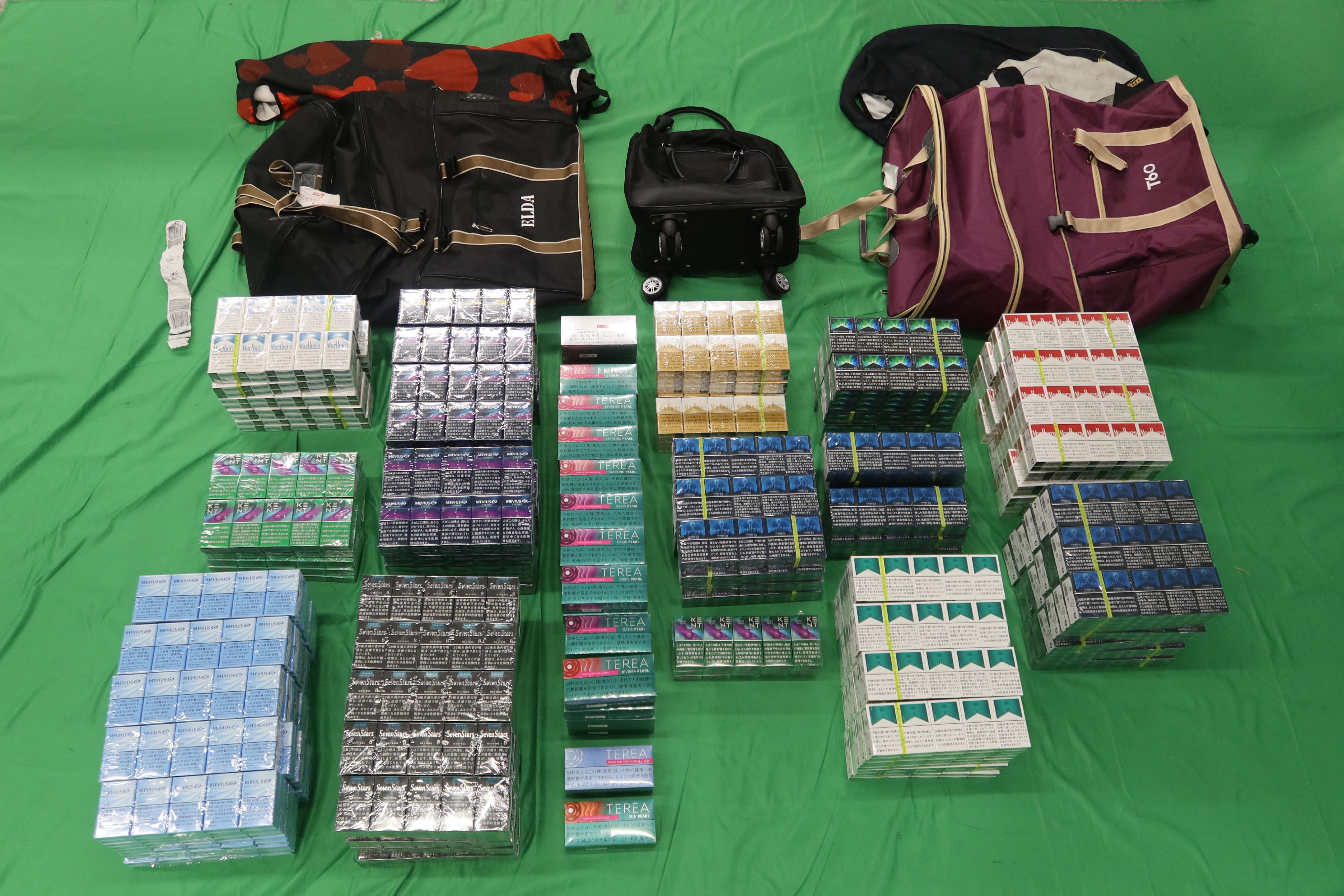 An incoming 49-year-old female passenger was sentenced to five months' imprisonment and fined $1,000 at the West Kowloon Magistrates' Courts today (July 23) for possessing duty-not-paid cigarettes and failing to declare them to Customs officers, as well as for importing alternative smoking products, in contravention of the Dutiable Commodities Ordinance and the Import and Export Ordinance. Photo shows the duty-not-paid cigarettes and alternative smoking products seized.

