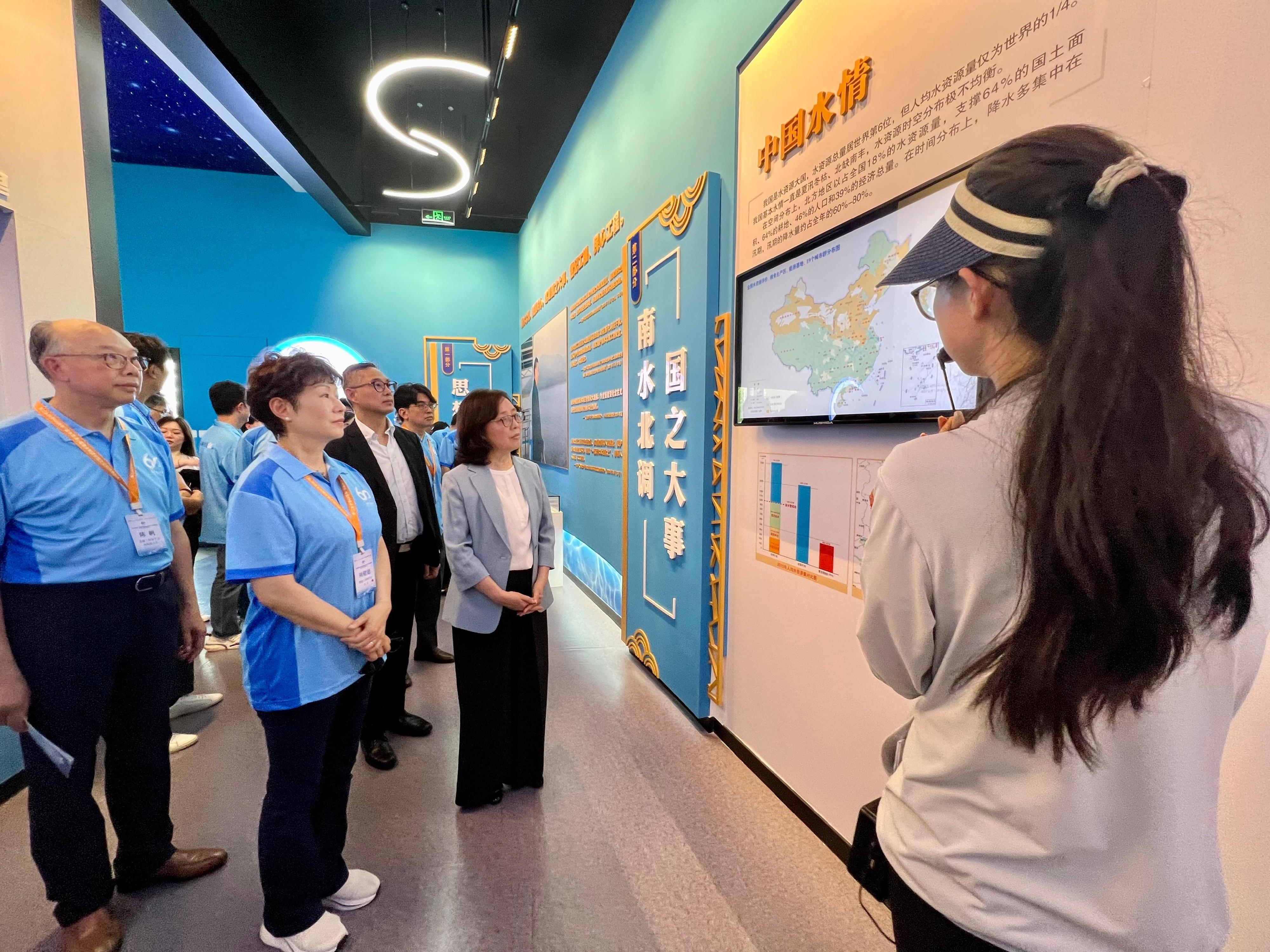 The Secretary for Development, Ms Bernadette Linn, began her visit to Beijing today (July 23). Photo shows Ms Linn (second right); and the Permanent Secretary for Development (Works), Mr Ricky Lau (third left), being briefed on the South-to-North Water Diversion Project in the  exhibition hall of the project when touring the Tuancheng Lake Regulating Pond with the study tour on national water infrastructure, culture and technology.