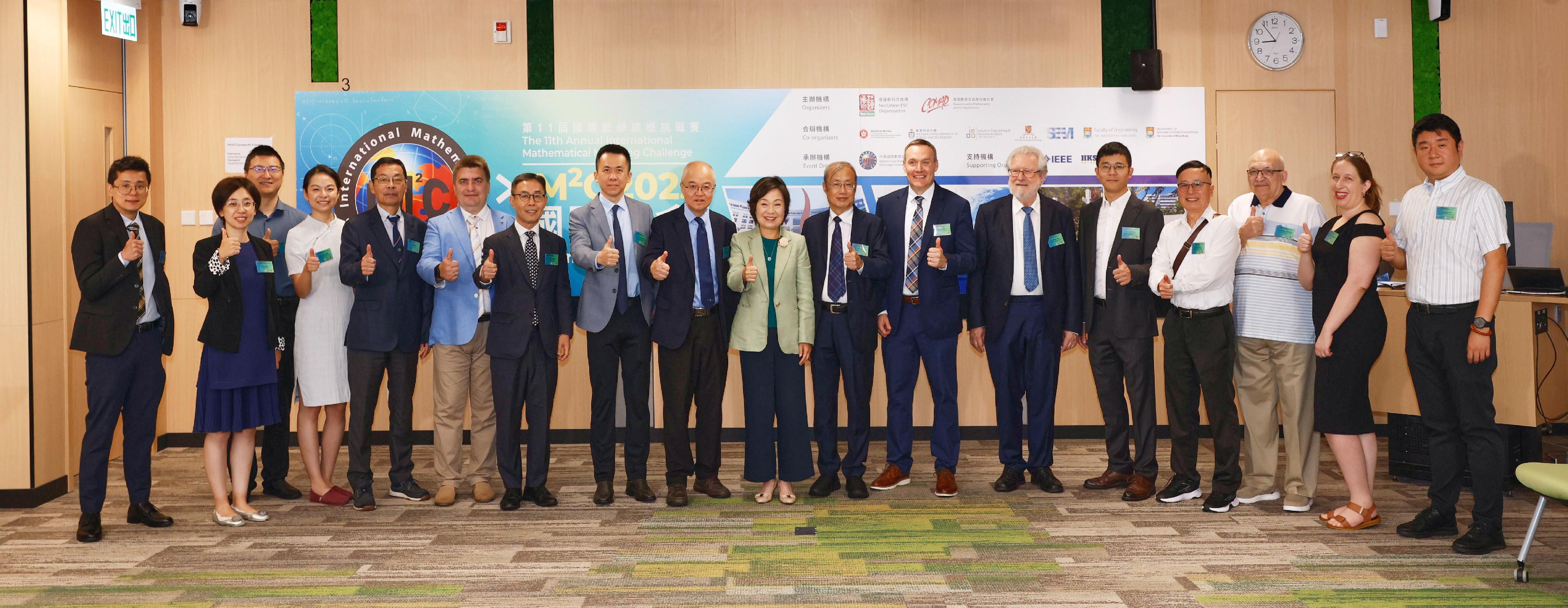 The Education Bureau co-organised the 11th Annual International Mathematical Modelling Challenge International Summit cum Award Ceremony with educational organisations and various local universities today (July 24). Photo shows the Secretary for Education, Dr Choi Yuk-lin (ninth right); the President of the International Commission on Mathematical Instruction and Emeritus Professor of the University of Hong Kong, Professor Frederick Leung (eighth right); Chair Professor of the Department of Mathematics and Department of Industrial Engineering and Decision Analytics of the Hong Kong University of Science and Technology Professor Wang Yang (ninth left); the Head of the Department of Industrial Engineering and Decision Analytics of the Hong Kong University of Science and Technology, Professor Zhang Jiheng (eighth left), and other guests.

