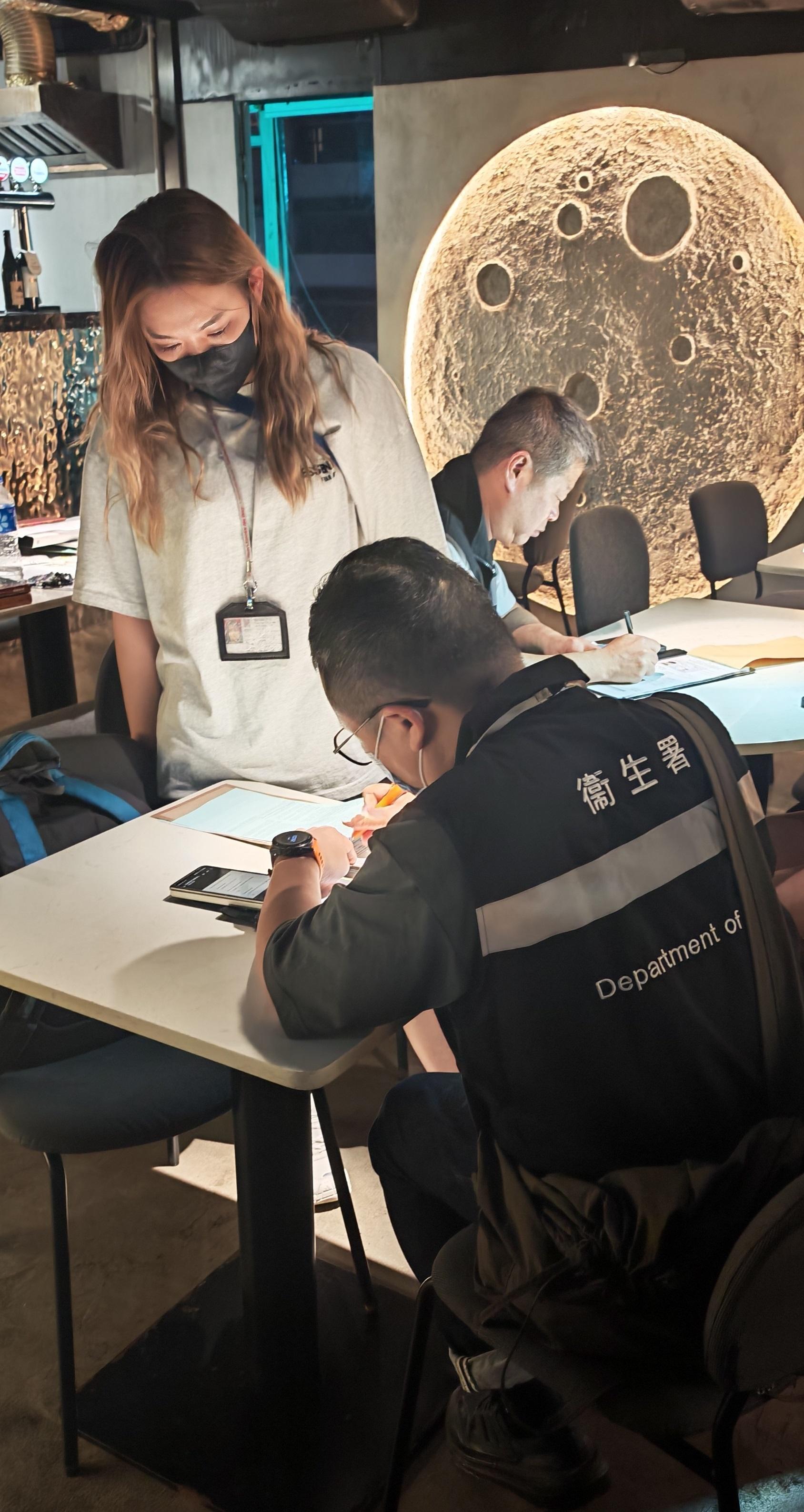 The Tobacco and Alcohol Control Office (TACO) of the Department of Health continued to clamp down on illegal waterpipe smoking in no-smoking areas by conducting another enforcement operation, codenamed "Pipepurge", in Mong Kok last night (July 24) and officers issued a total of 11 fixed penalty notices. Photo shows TACO officers taking enforcement action inside a bar.  