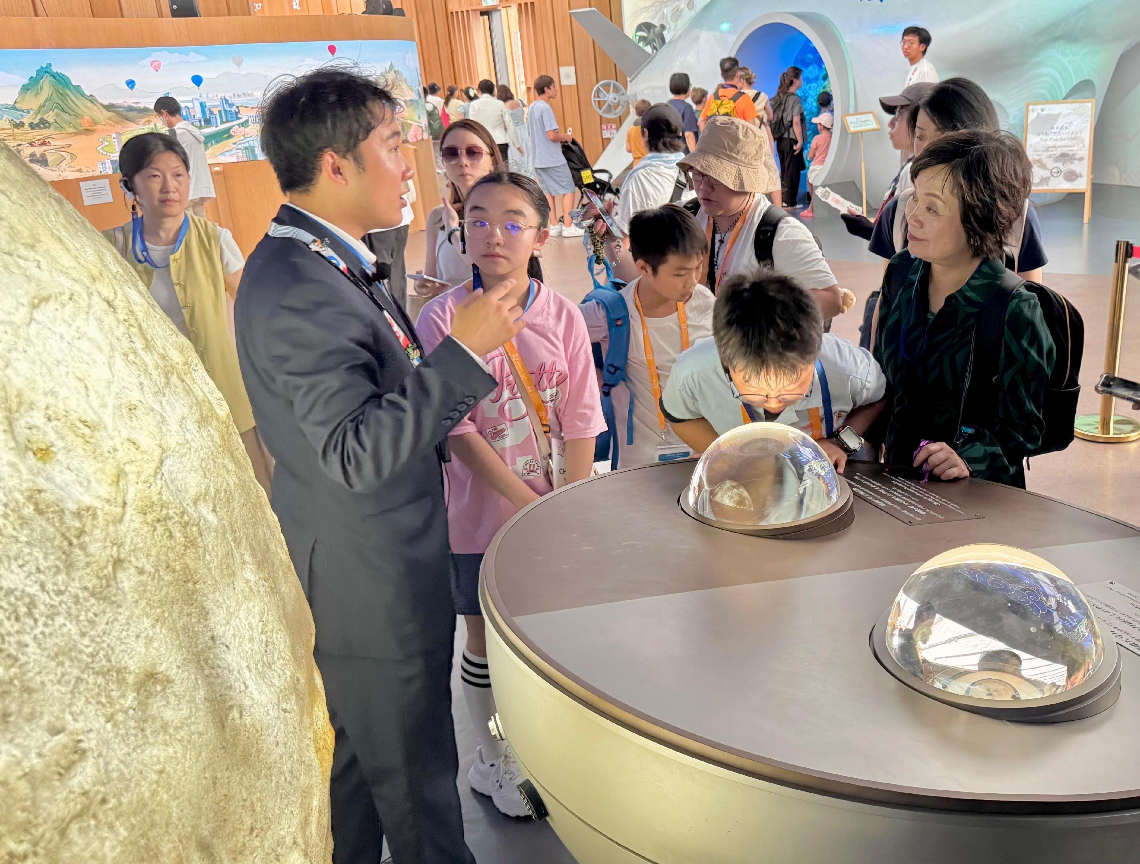 The Secretary for Education, Dr Choi Yuk-lin (first right), tours the China Pavilion at the World Expo 2025 Osaka, Kansai, in Japan on July 28 with a group of Hong Kong students joining the summer overseas exchange trip organised by the Jockey Club Life Adventure Opportunity Hub.