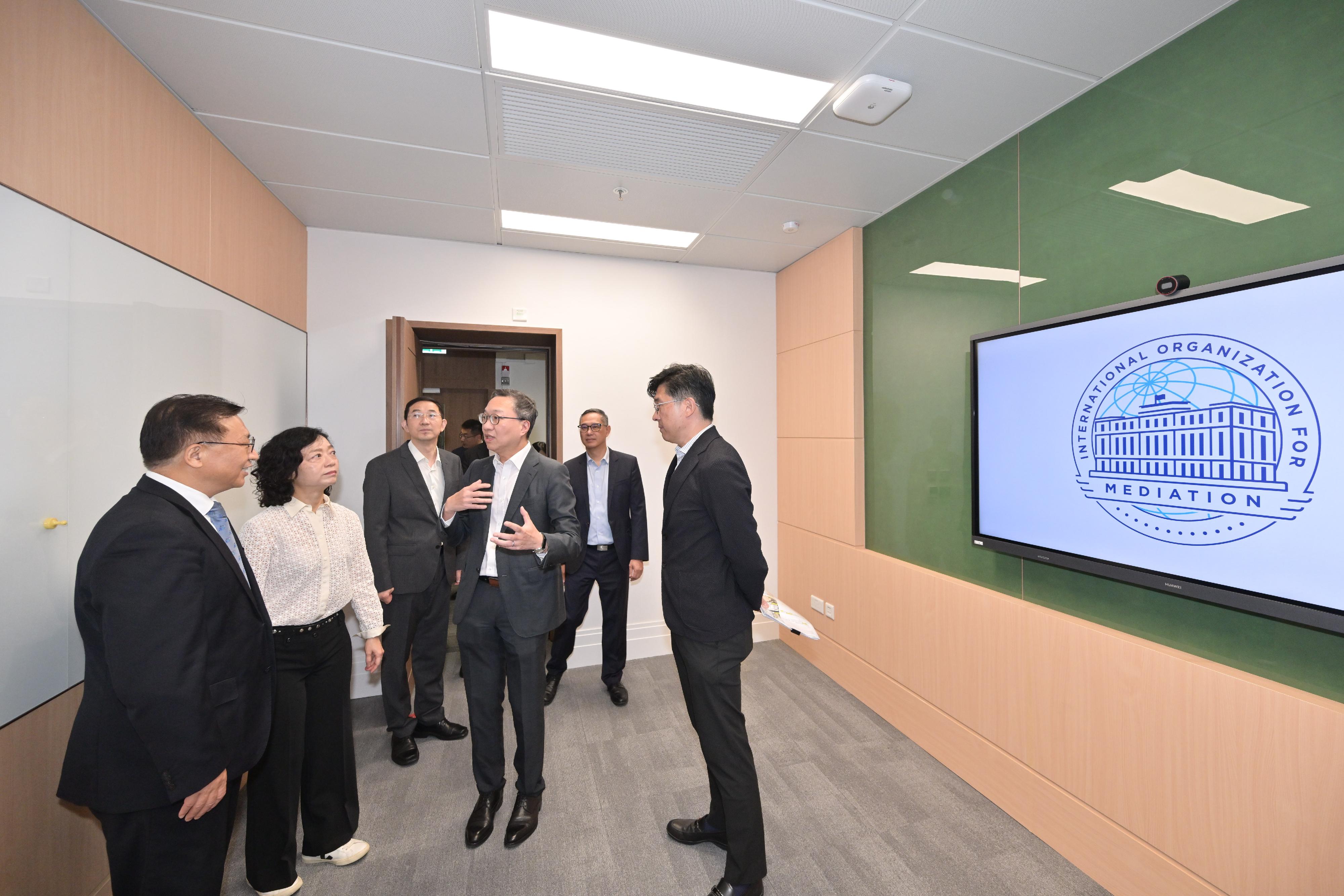 With the renovation project for the International Organization for Mediation (IOMed) headquarters building completed, the Secretary for Justice, Mr Paul Lam, SC, and the Commissioner of the Ministry of Foreign Affairs in the Hong Kong Special Administrative Region, Mr Cui Jianchun, visited the headquarters building today (July 30). Photo shows (from left) Mr Cui; the Director of Administration and Development of the Department of Justice, Ms Jessie Wong; the Director-General of the IOMed Preparatory Office, Dr Sun Jin; Mr Lam; the Permanent Secretary for Development (Works), Mr Ricky Lau; and the Director of Architectural Services, Mr Michael Li, visiting the breakout room.