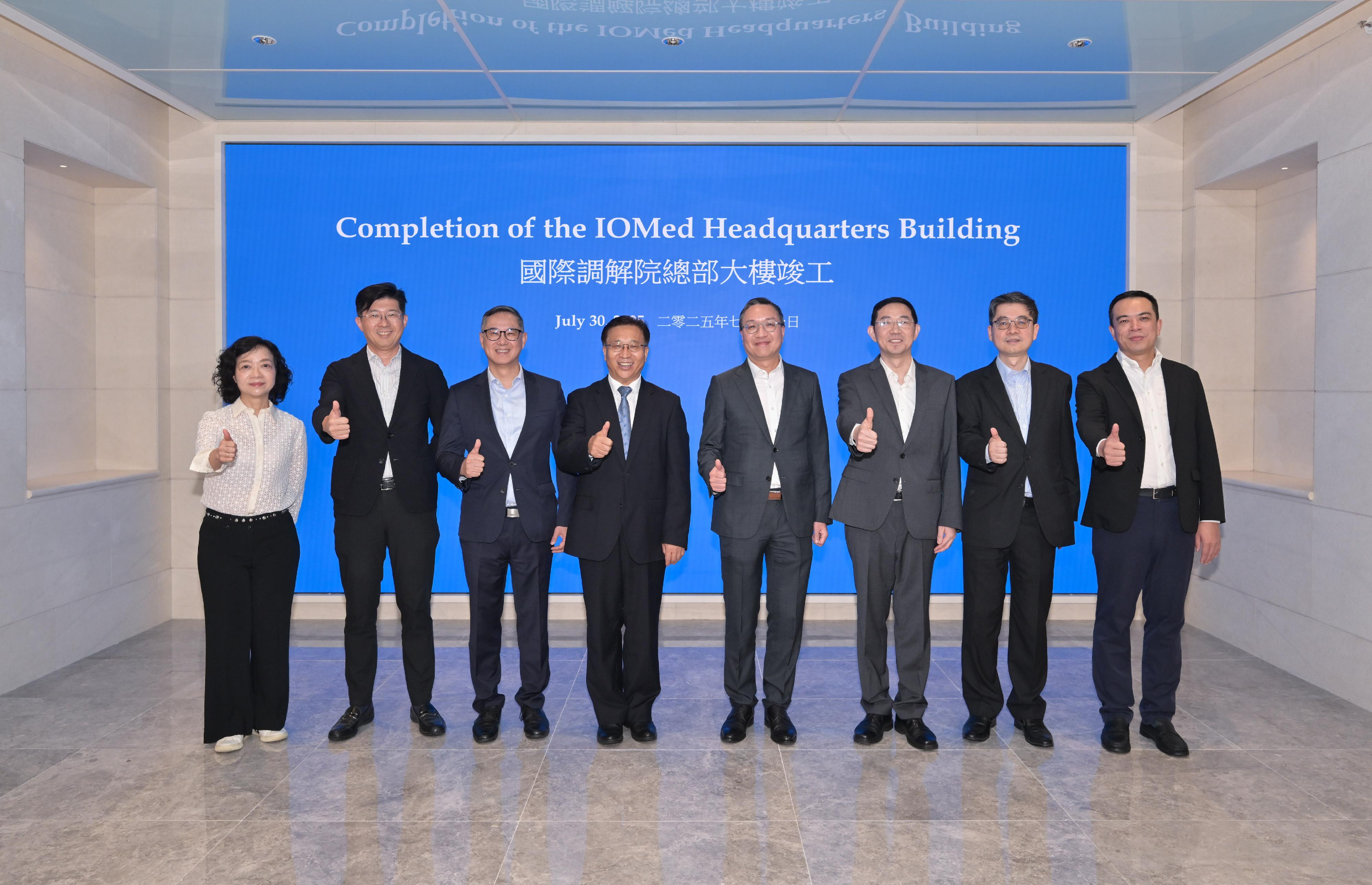 With the renovation project for the International Organization for Mediation (IOMed) headquarters building completed, the Secretary for Justice, Mr Paul Lam, SC, and the Commissioner of the Ministry of Foreign Affairs in the Hong Kong Special Administrative Region, Mr Cui Jianchun, visited the headquarters building today (July 30). Photo shows (from left) the Director of Administration and Development of the Department of Justice (DoJ), Ms Jessie Wong; the Director of Architectural Services, Mr Michael Li; the Permanent Secretary for Development (Works), Mr Ricky Lau; Mr Cui; Mr Lam; the Director-General of the IOMed Preparatory Office, Dr Sun Jin; the Law Officer (International Law) of the DoJ, Dr James Ding; and the Executive Director and Chief Executive Officer of the China State Construction International Holdings Limited, Mr Wang Xiaoguang, at the headquarters building.