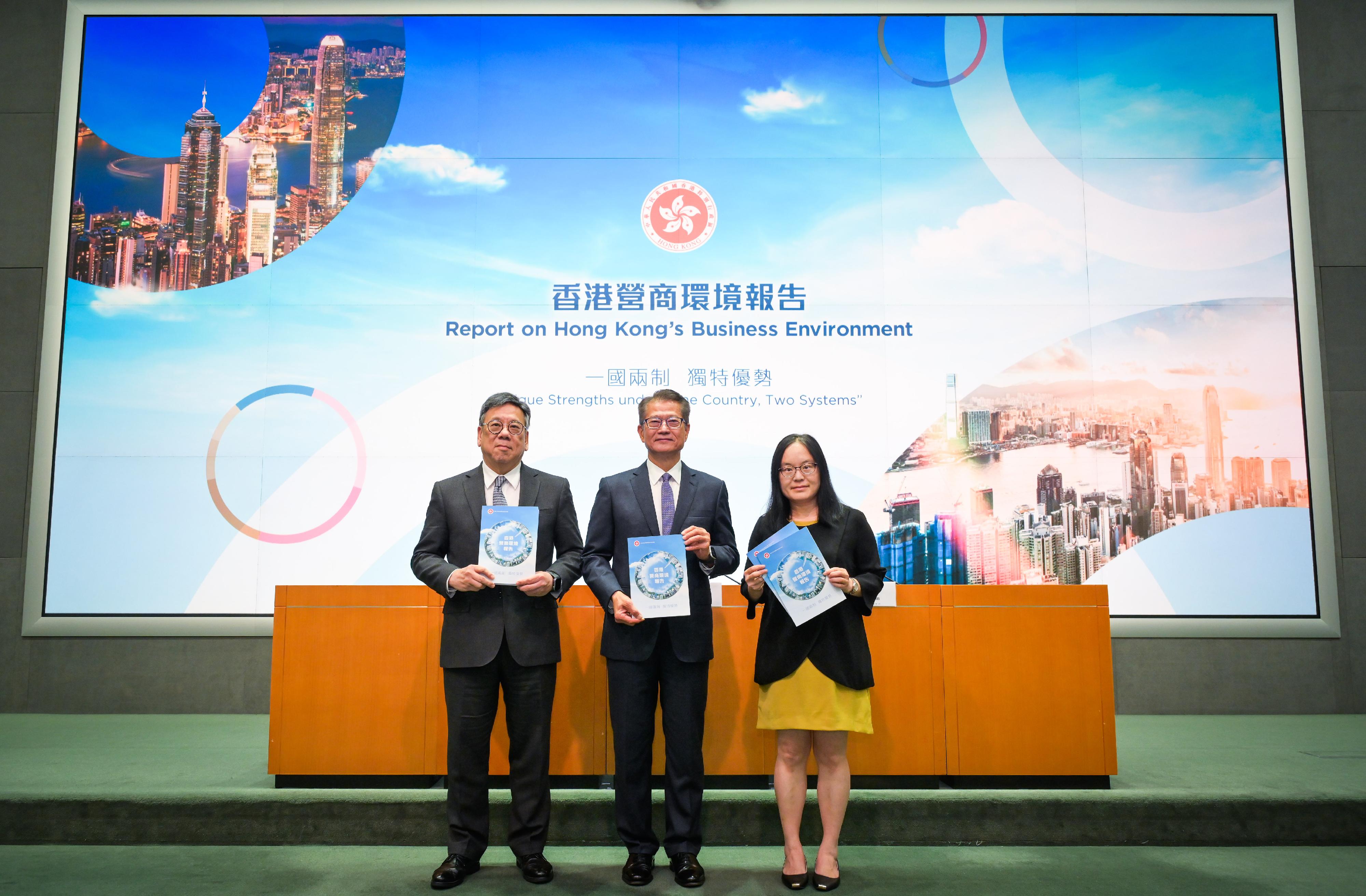 The Financial Secretary, Mr Paul Chan (centre), accompanied by the Secretary for Commerce and Economic Development, Mr Algernon Yau (left), and the Acting Government Economist, Dr Cecilia Lam (right), meets the media today (July 30) on the release of the "Report on Hong Kong's Business Environment: Unique Strengths under 'One Country, Two Systems'".
