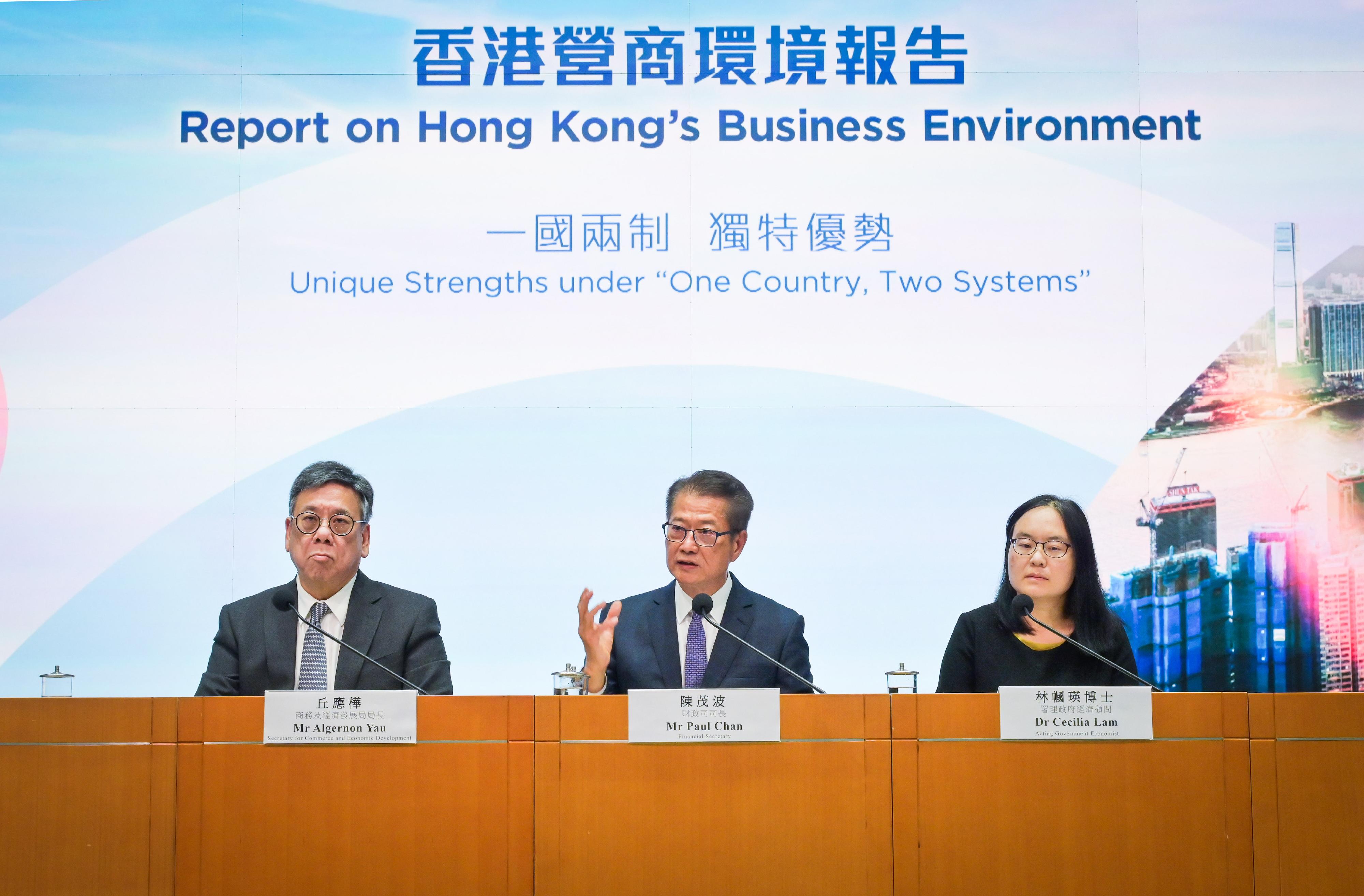 The Financial Secretary, Mr Paul Chan (centre), accompanied by the Secretary for Commerce and Economic Development, Mr Algernon Yau (left), and the Acting Government Economist, Dr Cecilia Lam (right), meets the media today (July 30) on the release of the "Report on Hong Kong's Business Environment: Unique Strengths under 'One Country, Two Systems'".