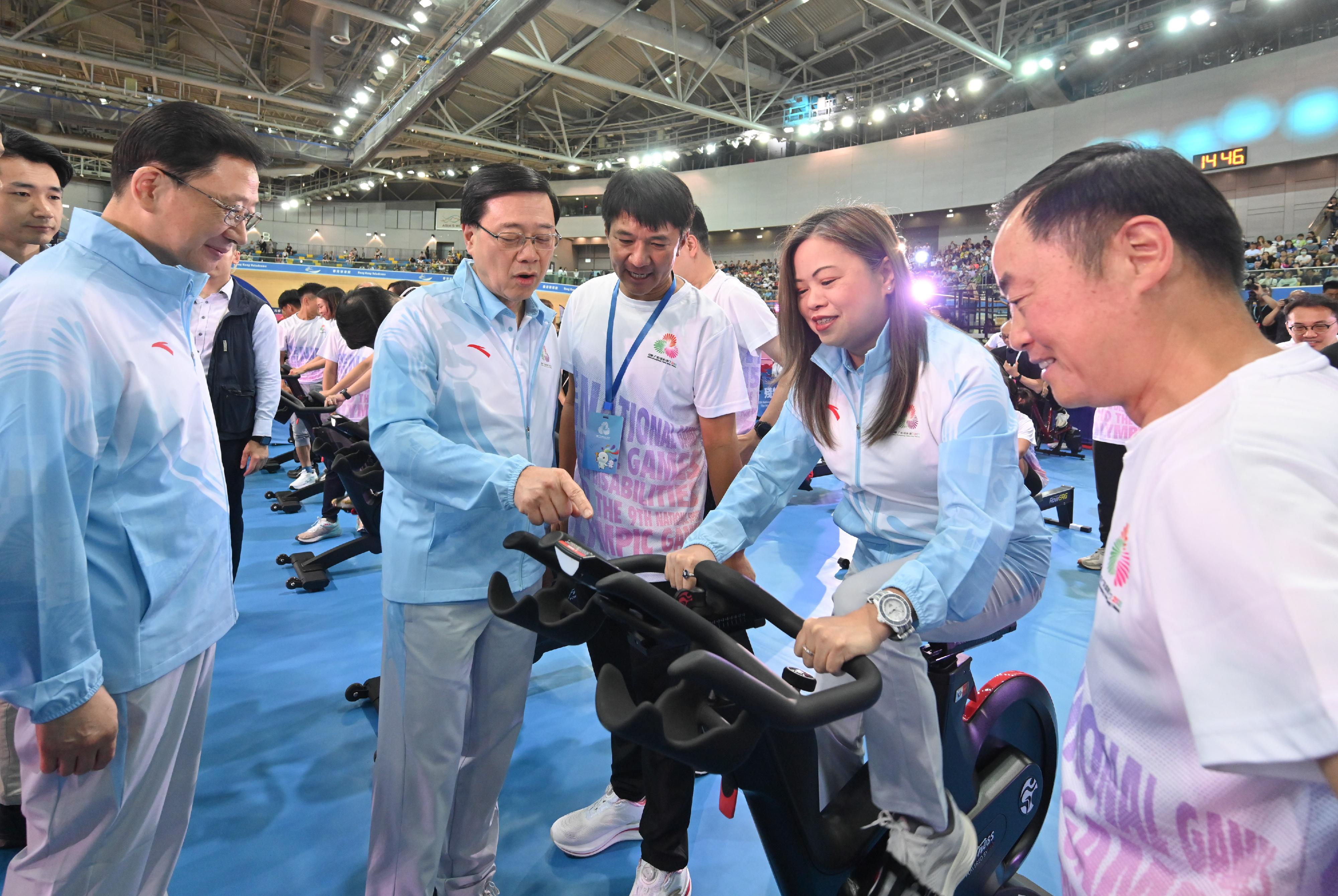 The Chief Executive, Mr John Lee, attended the 100-day countdown event for the 15th National Games, the 12th National Games for Persons with Disabilities and the 9th National Special Olympic Games (Hong Kong) today (August 2). Photo shows Mr Lee (second left) cheering for athletes and representatives of government departments participating in the final 100 kilometers challenge of the "100-Day to the National Games - All Together for 1 Million KM Challenge".
