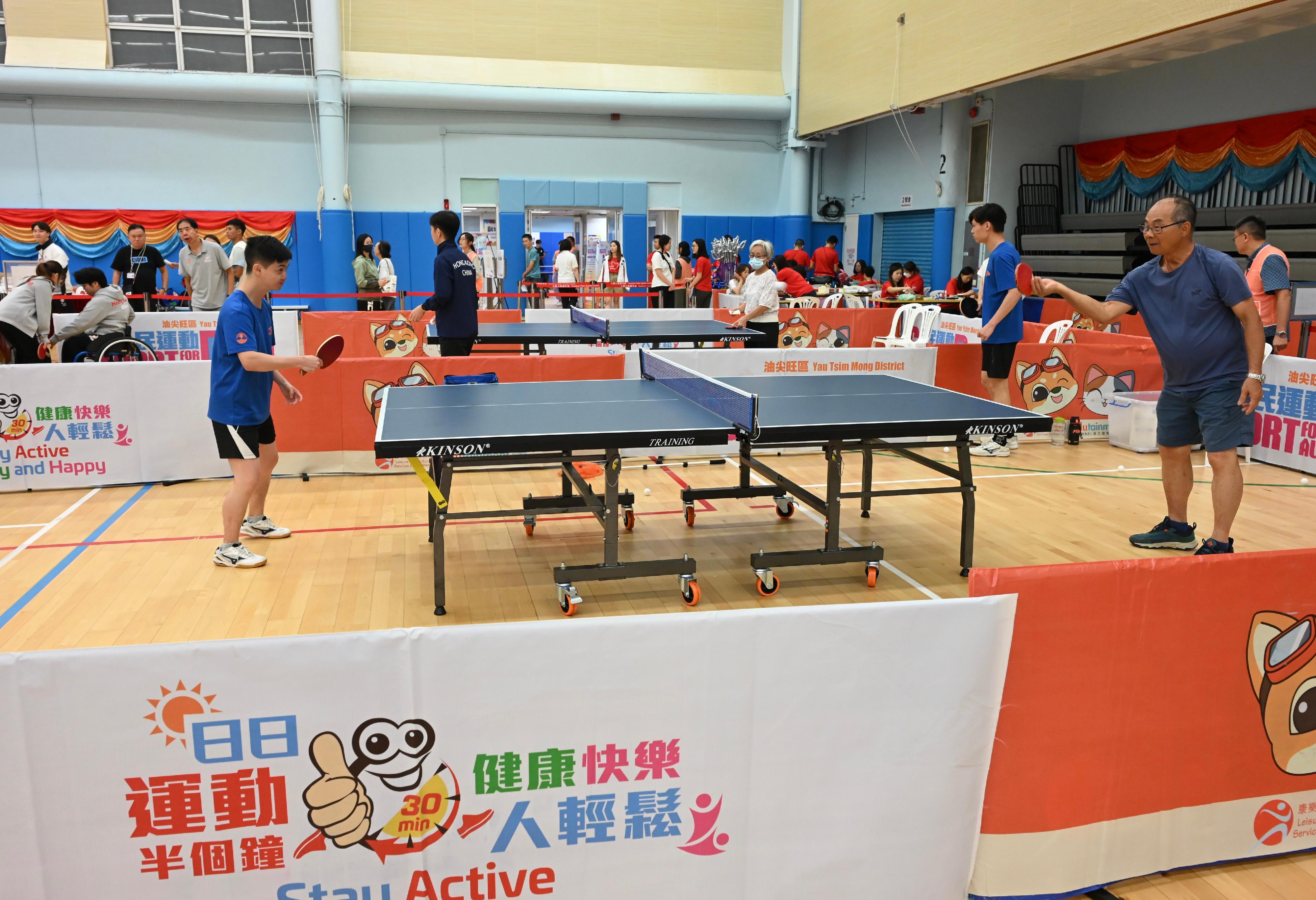The Sport For All Day 2025 was held by the Leisure and Cultural Services Department today (August 3) with free recreation and sports programmes at designated sports centres in 18 districts for the public to join. Photo shows members of the public taking part in the table tennis fun activities for persons with different abilities.