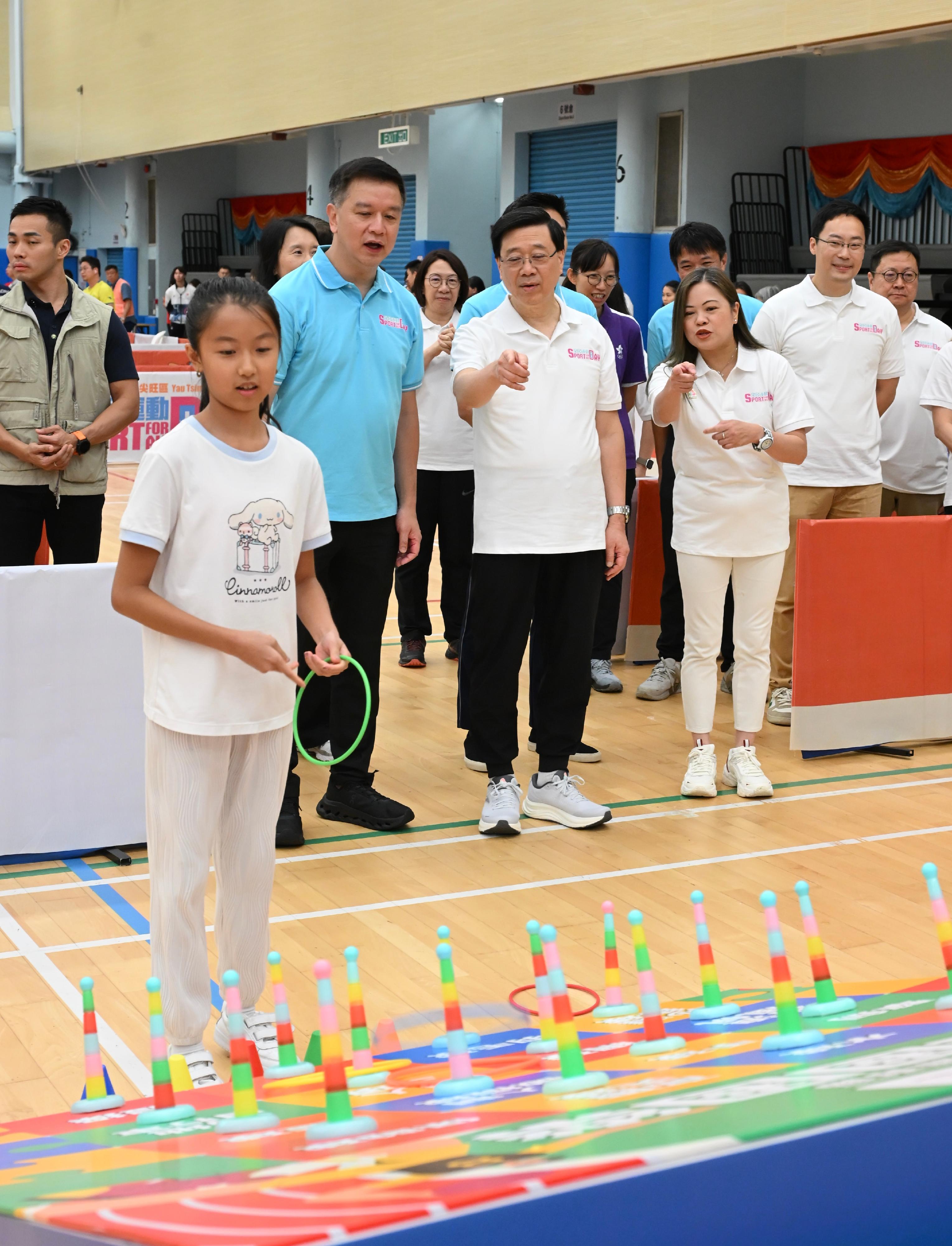 The Chief Executive, Mr John Lee, this afternoon (August 3) attended activities at the Kowloon Park Sports Centre main venue of the Sport For All Day 2025 held by the Leisure and Cultural Services Department, conveying to the public the benefits of regular exercise for physical and mental well-being. Photo shows Mr Lee (second row, centre) and other guests visiting the games booth of the Festival of Sport organised by the Sports Federation & Olympic Committee of Hong Kong, China. 
