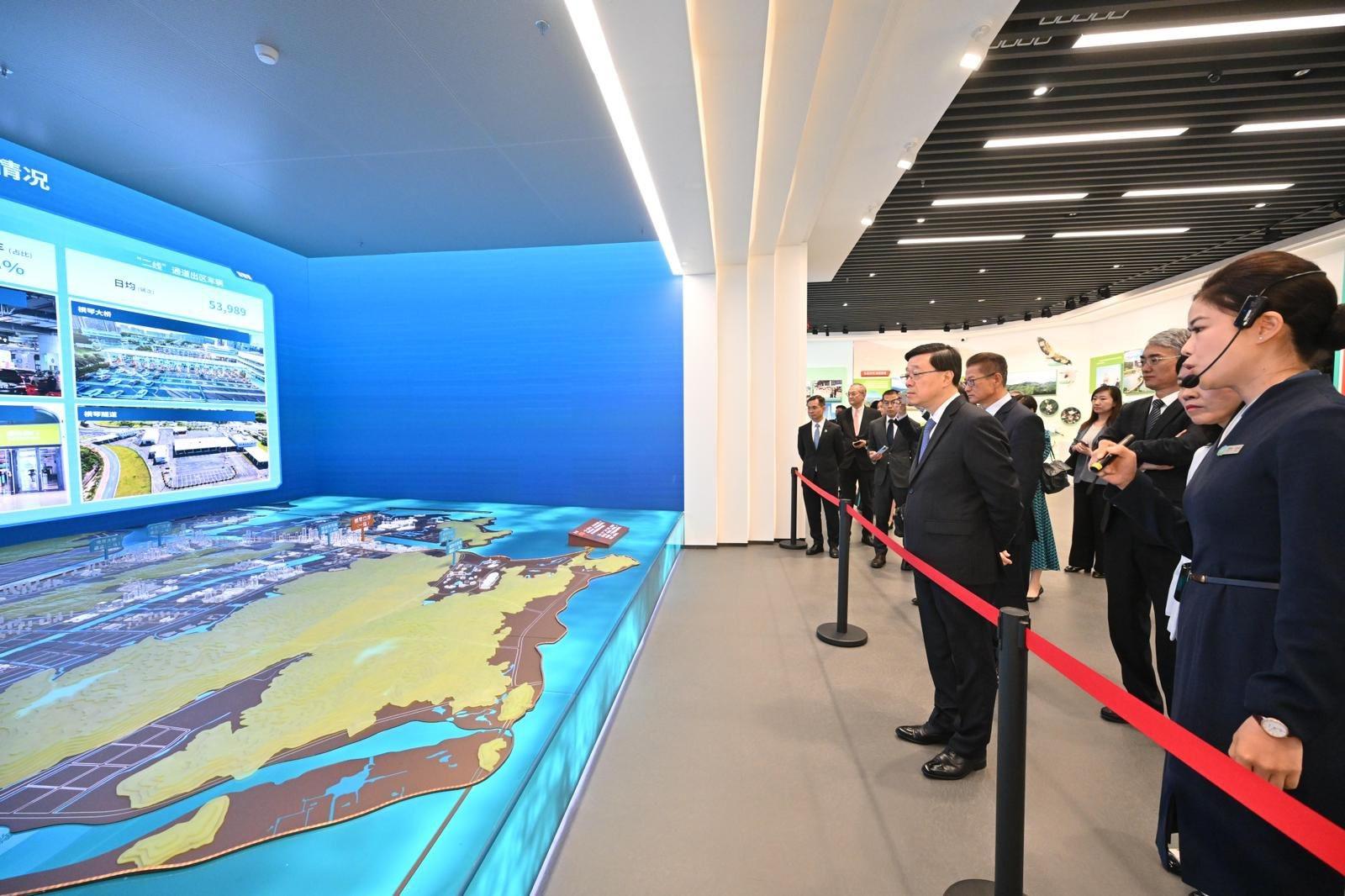 The Chief Executive, Mr John Lee, visited Macao today (August 5). Photo shows Mr Lee (front row, second left) visiting the Guangdong-Macao In-depth Cooperation Zone in Hengqin Planning Exhibition Hall.
