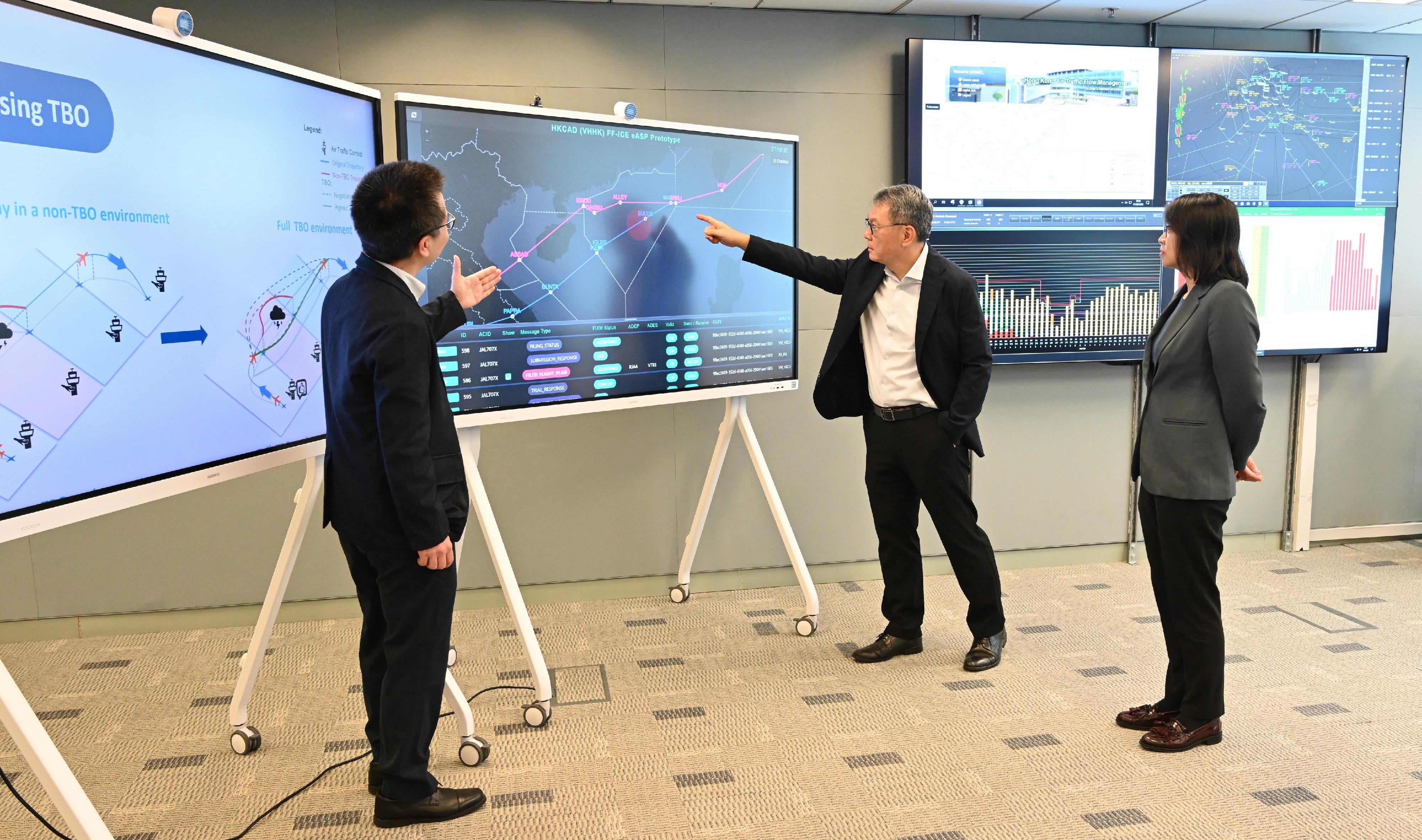 The Director-General of Civil Aviation, Mr Victor Liu (centre), accompanied by the Deputy Director-General of Civil Aviation, Miss Clara Wong (right), visited the Civil Aviation Department Innovation Lab and were updated on Flight and Flow Information for a Collaborative Environment, Trajectory-Based Operations, as well as the latest developments of regional air traffic management projects today (August 7).
